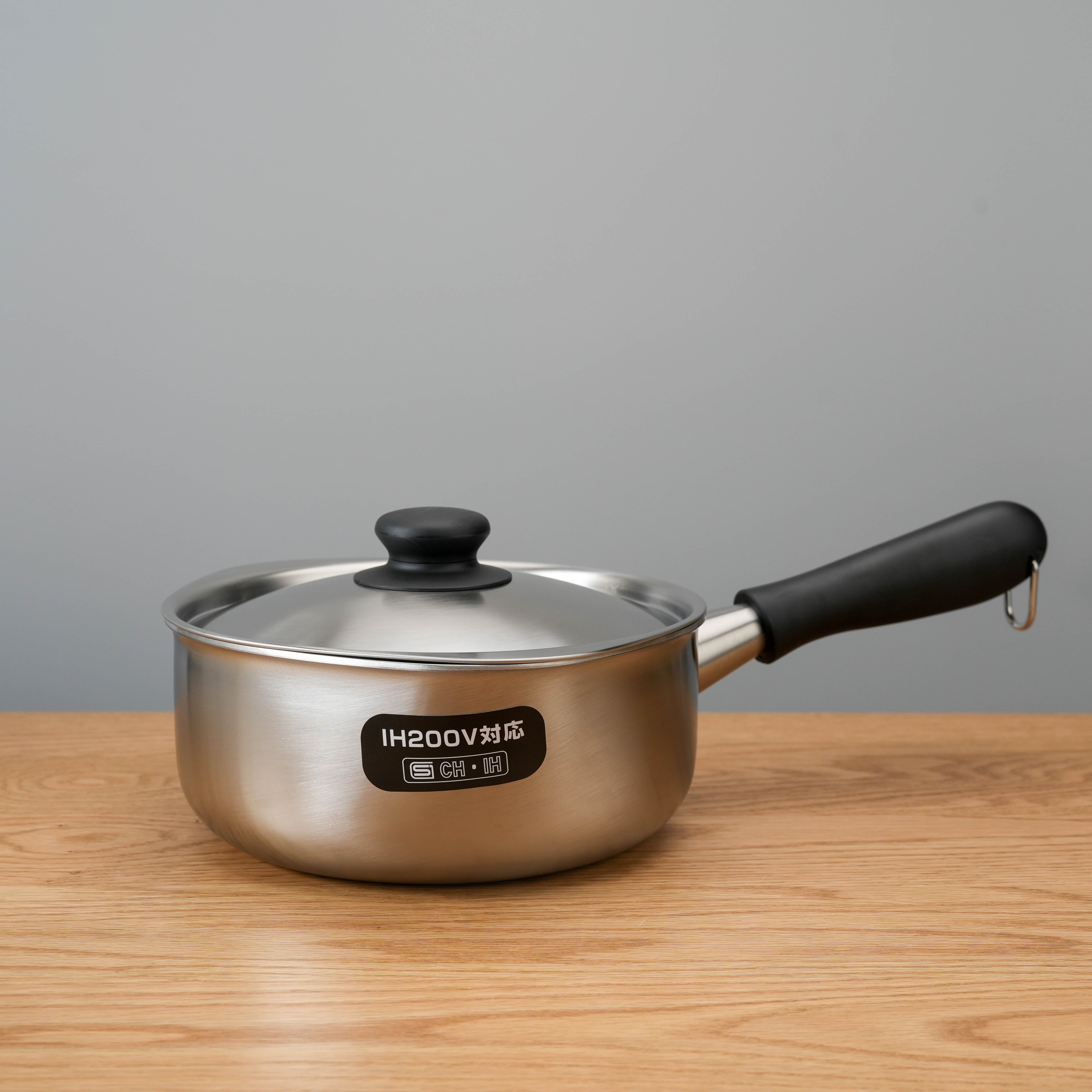 Sori Yanagi 3-Ply Stainless Steel Induction Saucepan with lid and ergonomic handle, ideal for modern Japanese kitchen design.