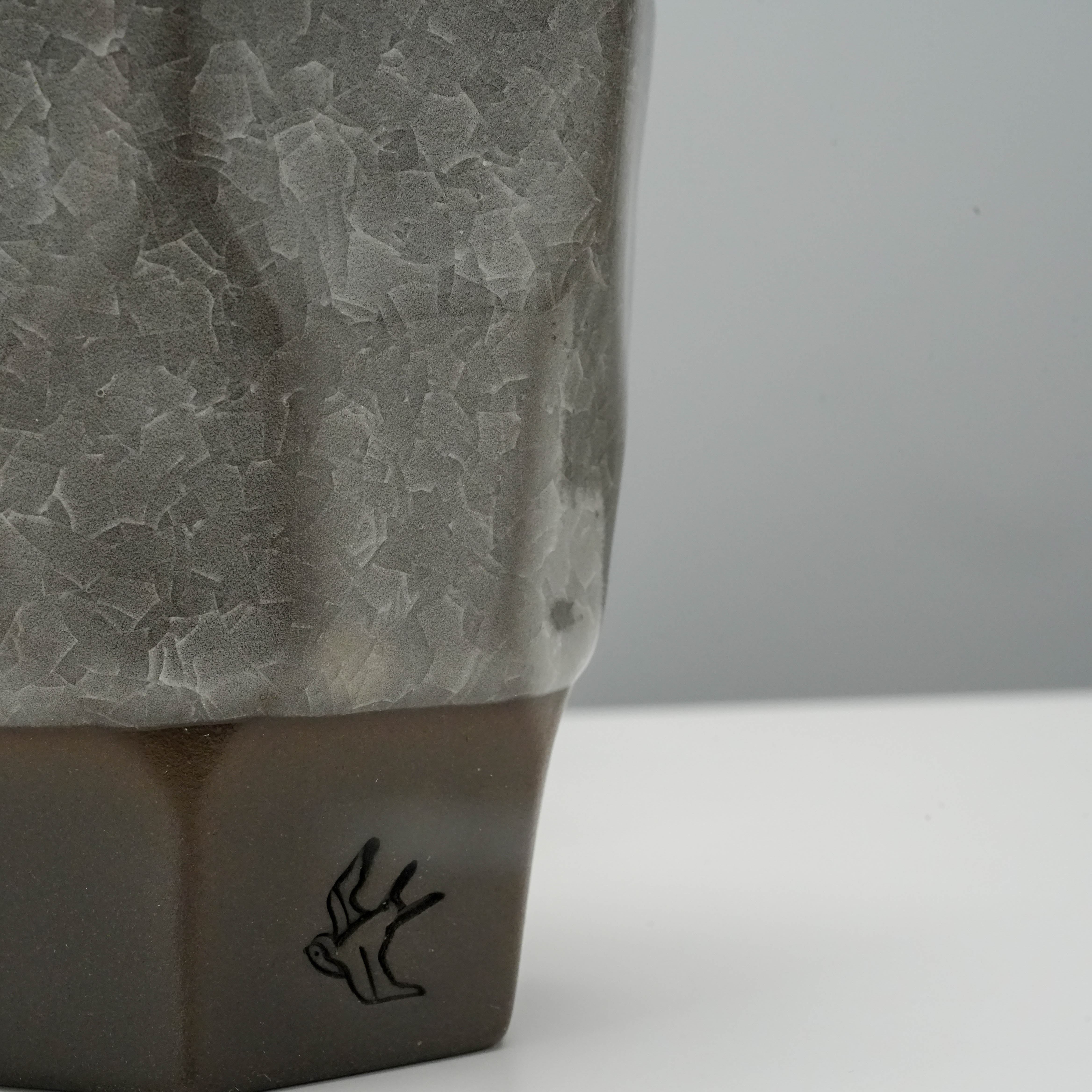 Close-up of Tsubame Kobo Free Cup - Clay Craft Ice Crack highlighting the handcrafted texture and swallow logo on the black clay base.