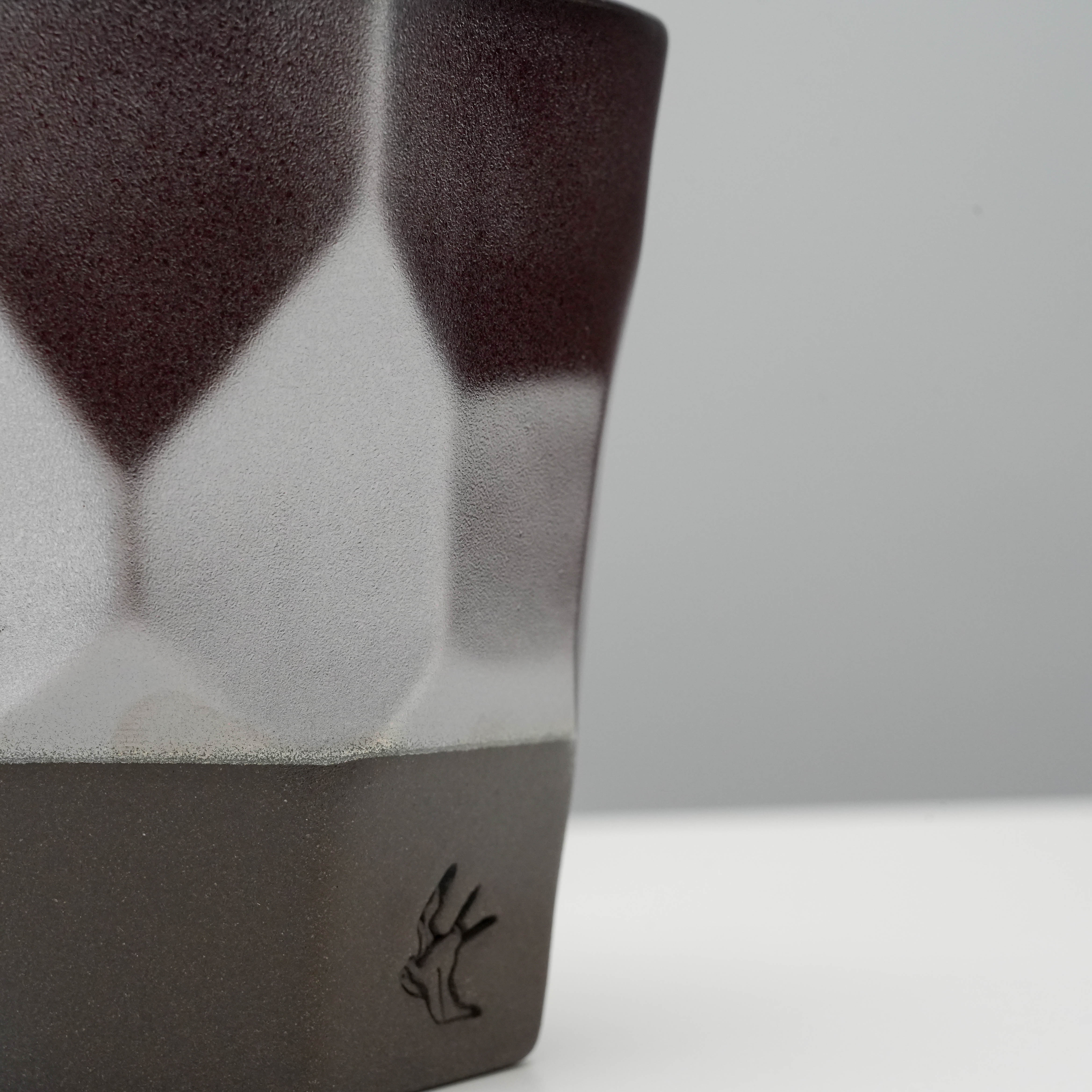 Close-up of Tsubame Kobo Free Cup Matte Silver highlighting the textured metallic glaze and embossed logo on black clay base.