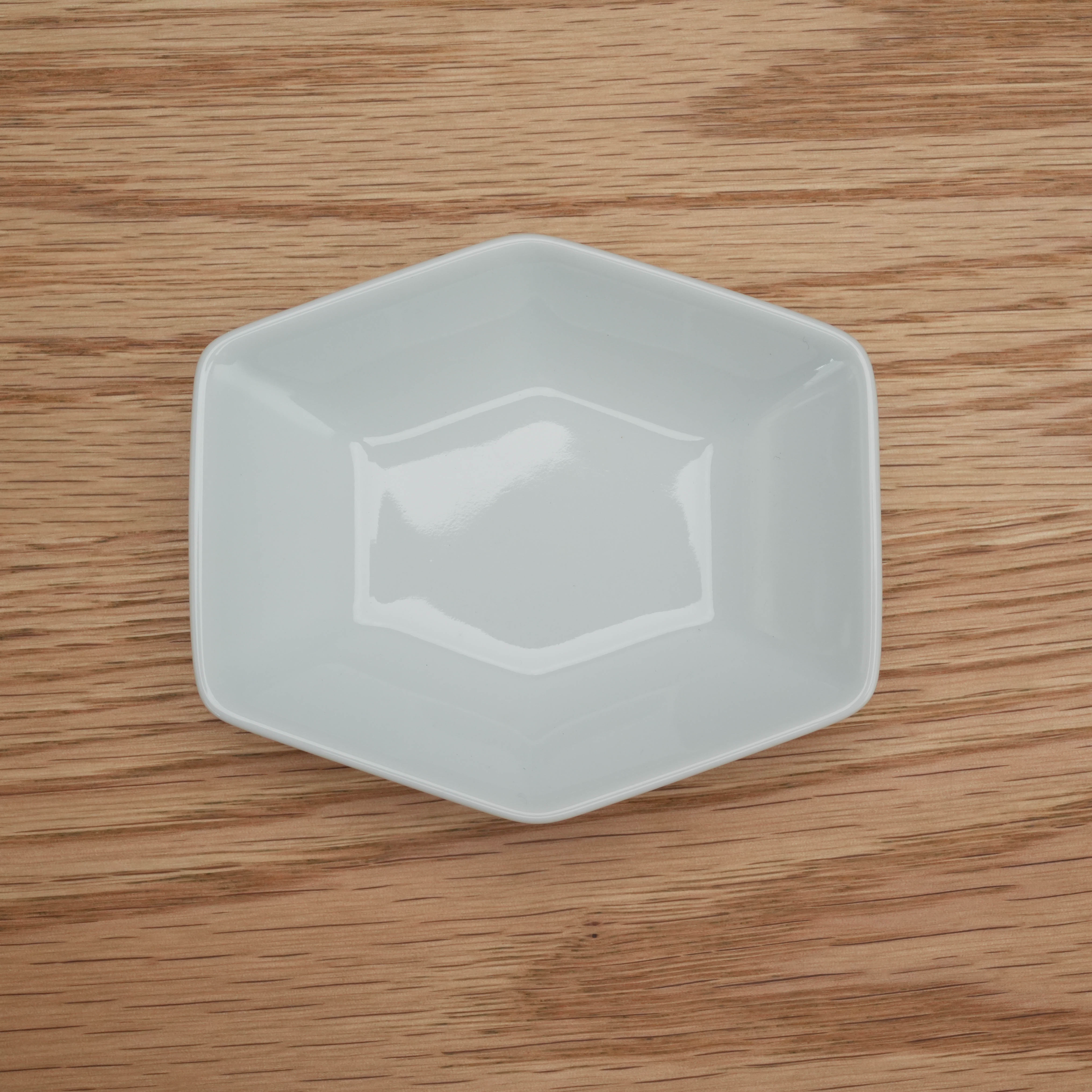 Top view of white Hakusan Kikkou Sauce Dish with geometric tortoiseshell design, blending Japanese tradition with modern serveware.