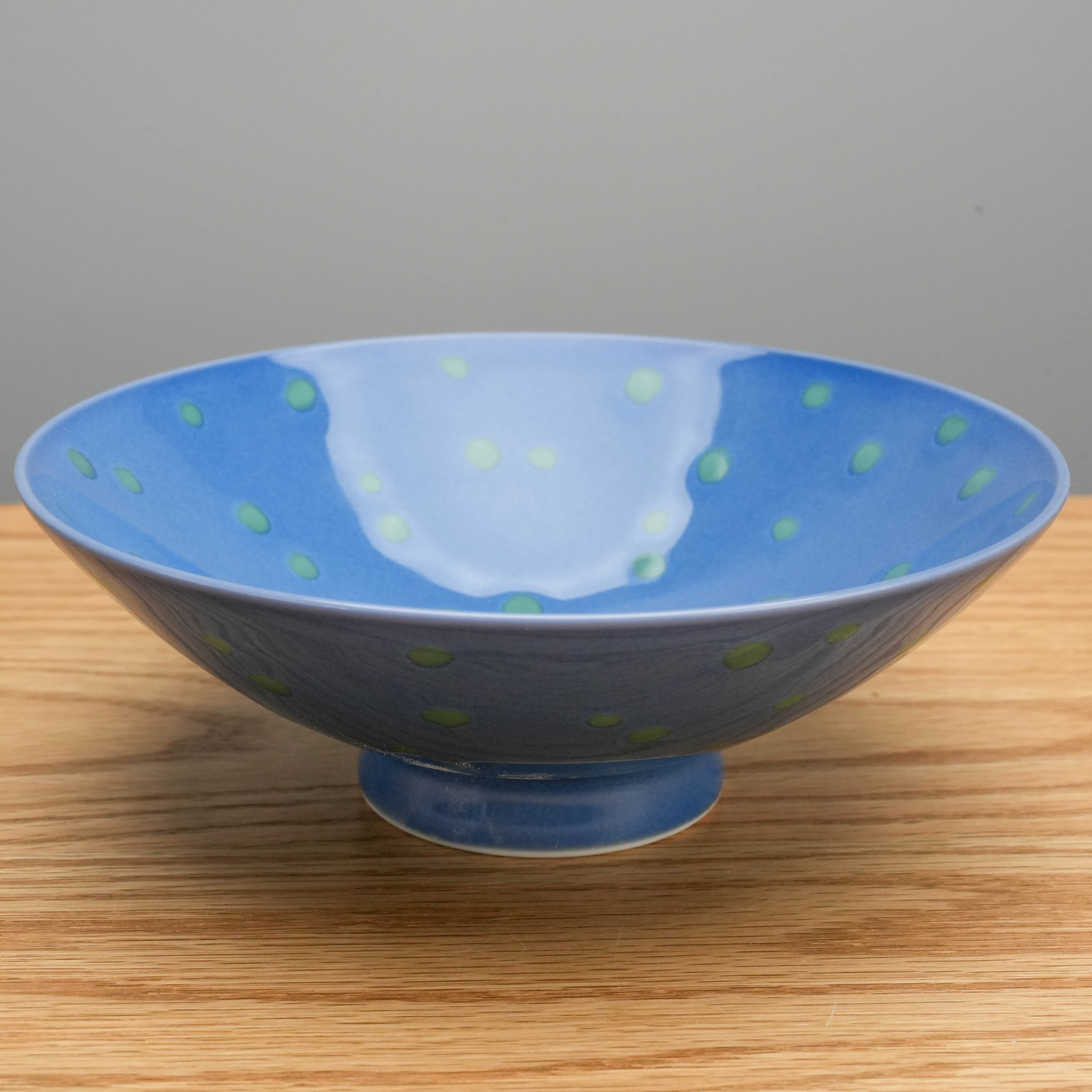 Side angle of Hasami Ware Green Dot Bowl - Rice Bowl highlighting its elegant footed base and award-winning minimalist design.