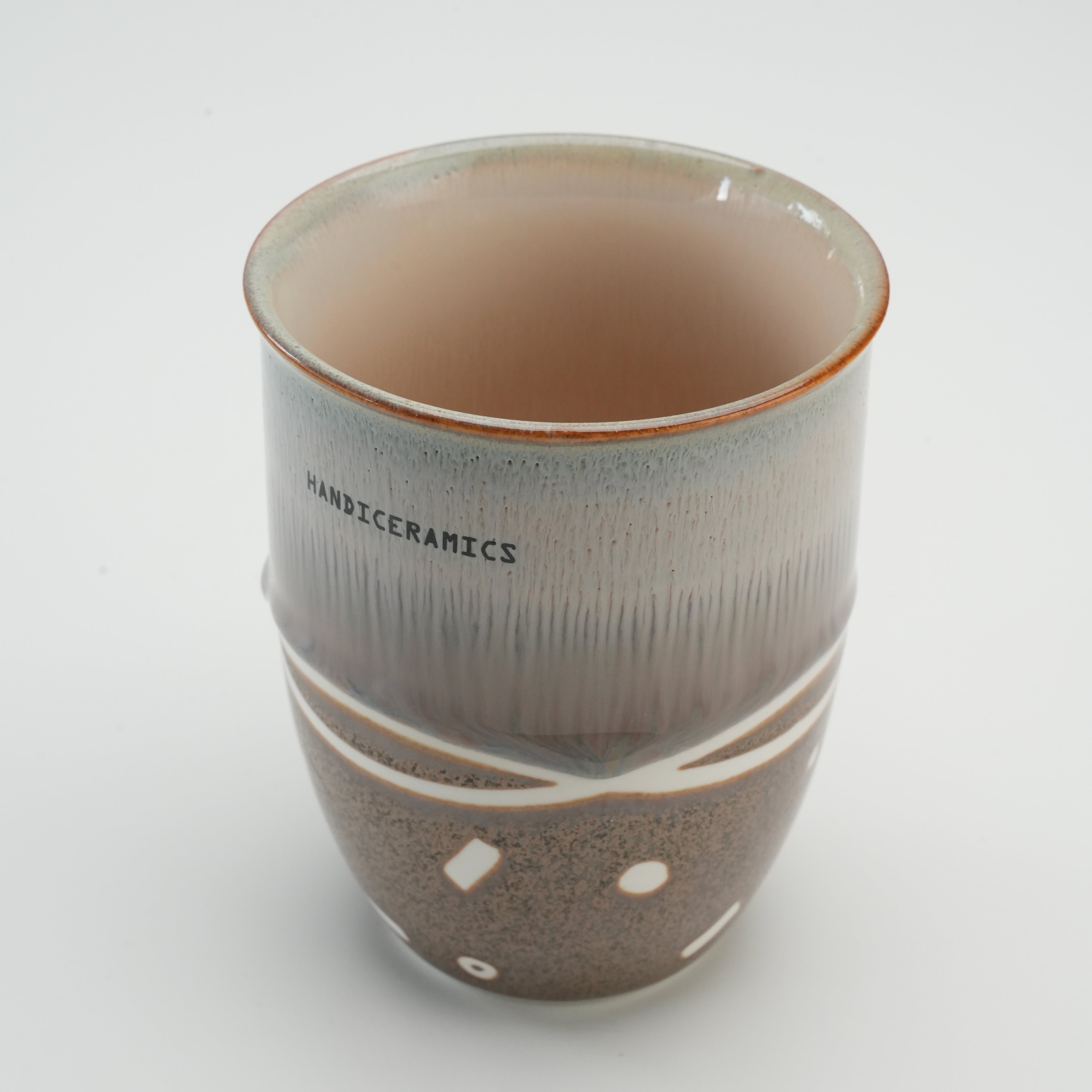 Interior view of Handiceramics Travel Cup in Brown Sugar, showing glazed ceramic finish and handcrafted detailing without lid.