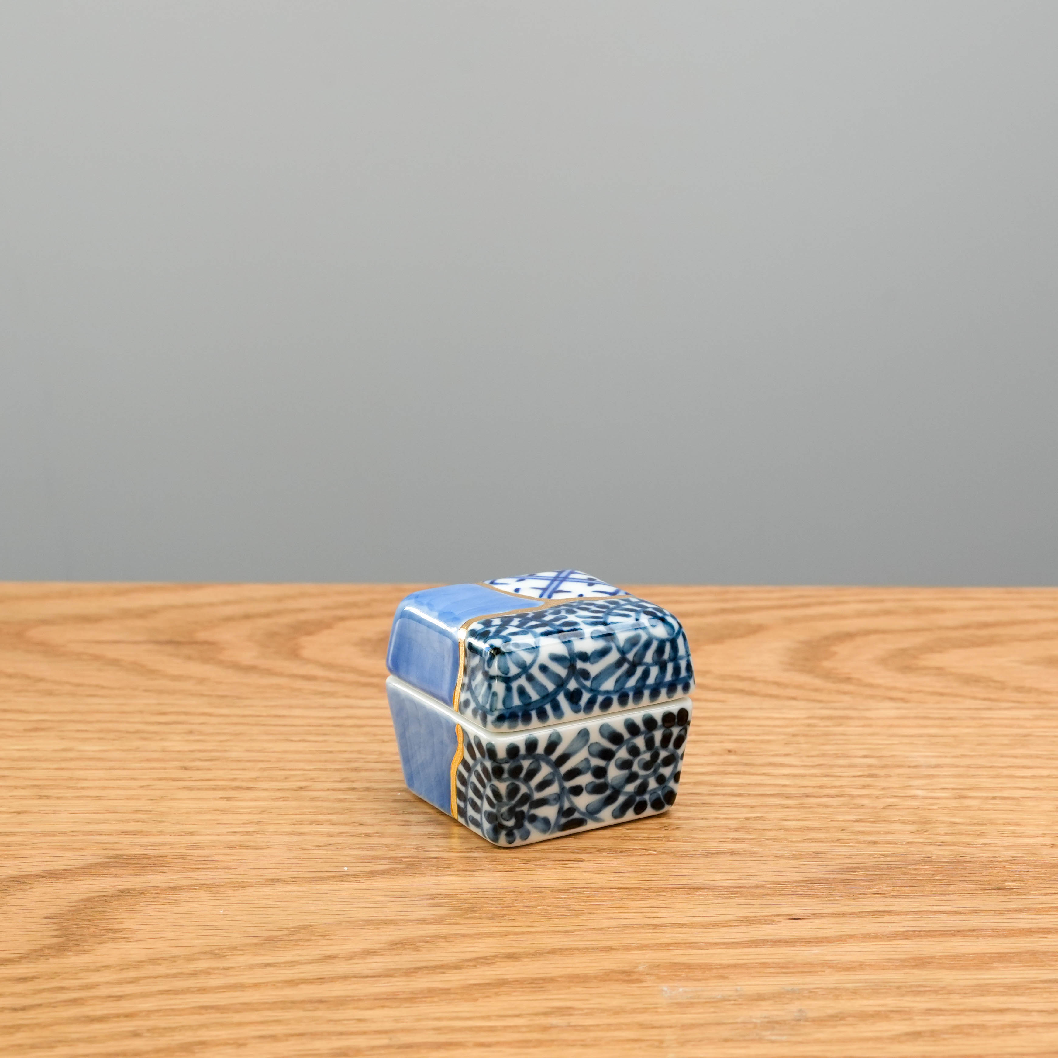 Back view of Arita kintsugi-style Delicacy Container featuring floral and geometric Japanese patterns with gold accents. Compact and decorative.