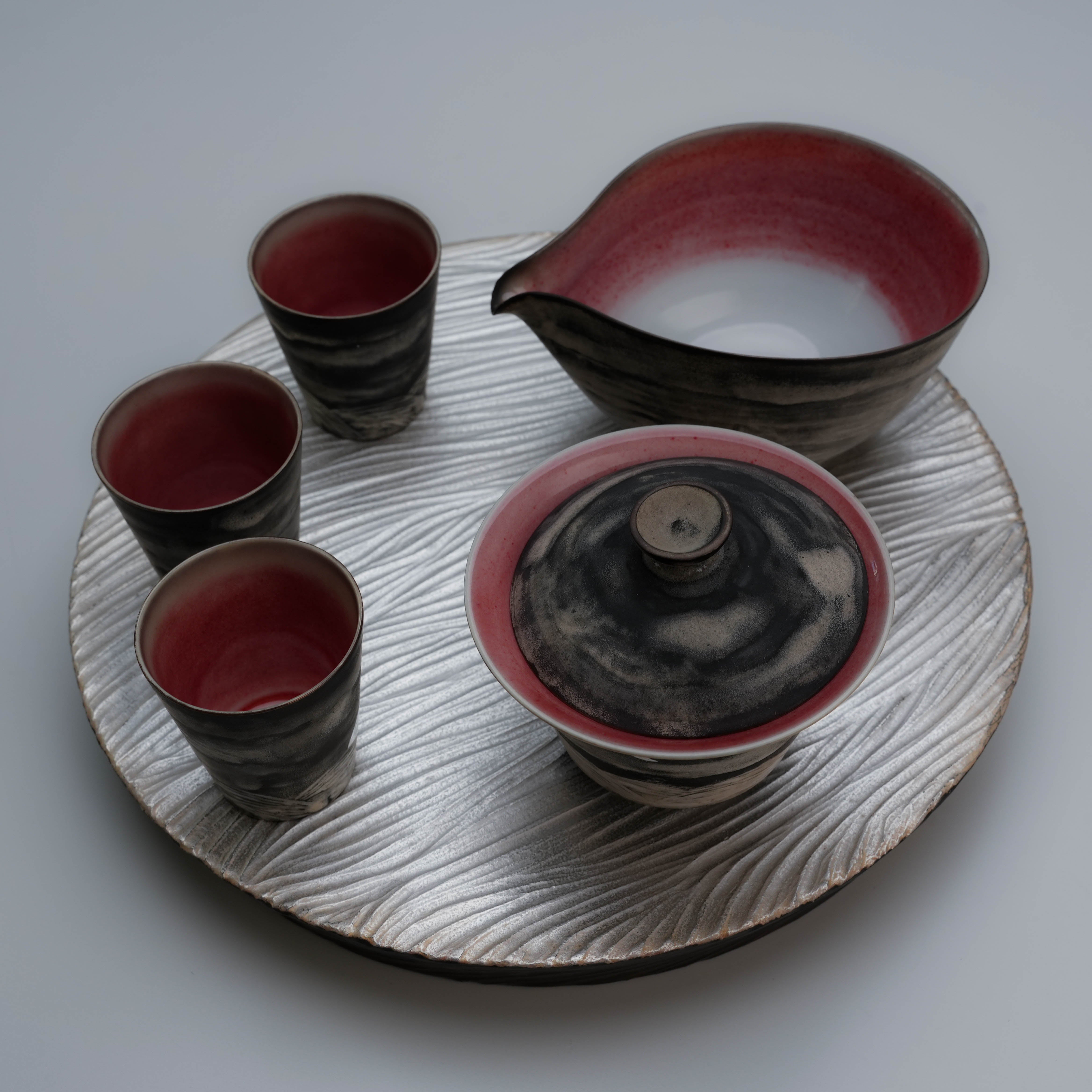 Complete Lonesome Studio Qushui Tea Set on silver textured tray, featuring red-glazed interiors and moonlit landscape designs for Gongfu Cha.