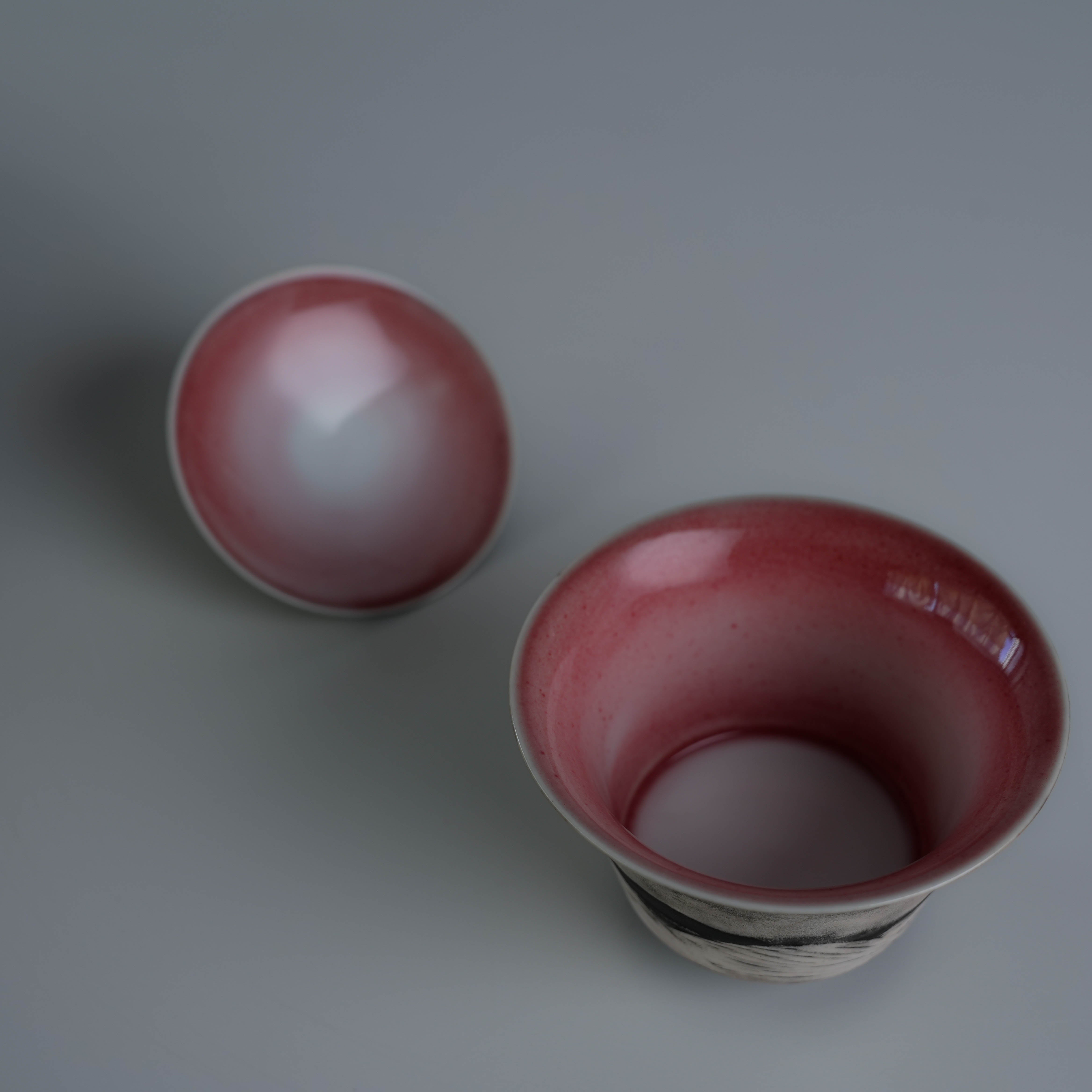 Top view of Lonesome Studio Qushui tea cup with red glaze and matching lid, part of handmade silver glaze Gongfu Cha tea set.