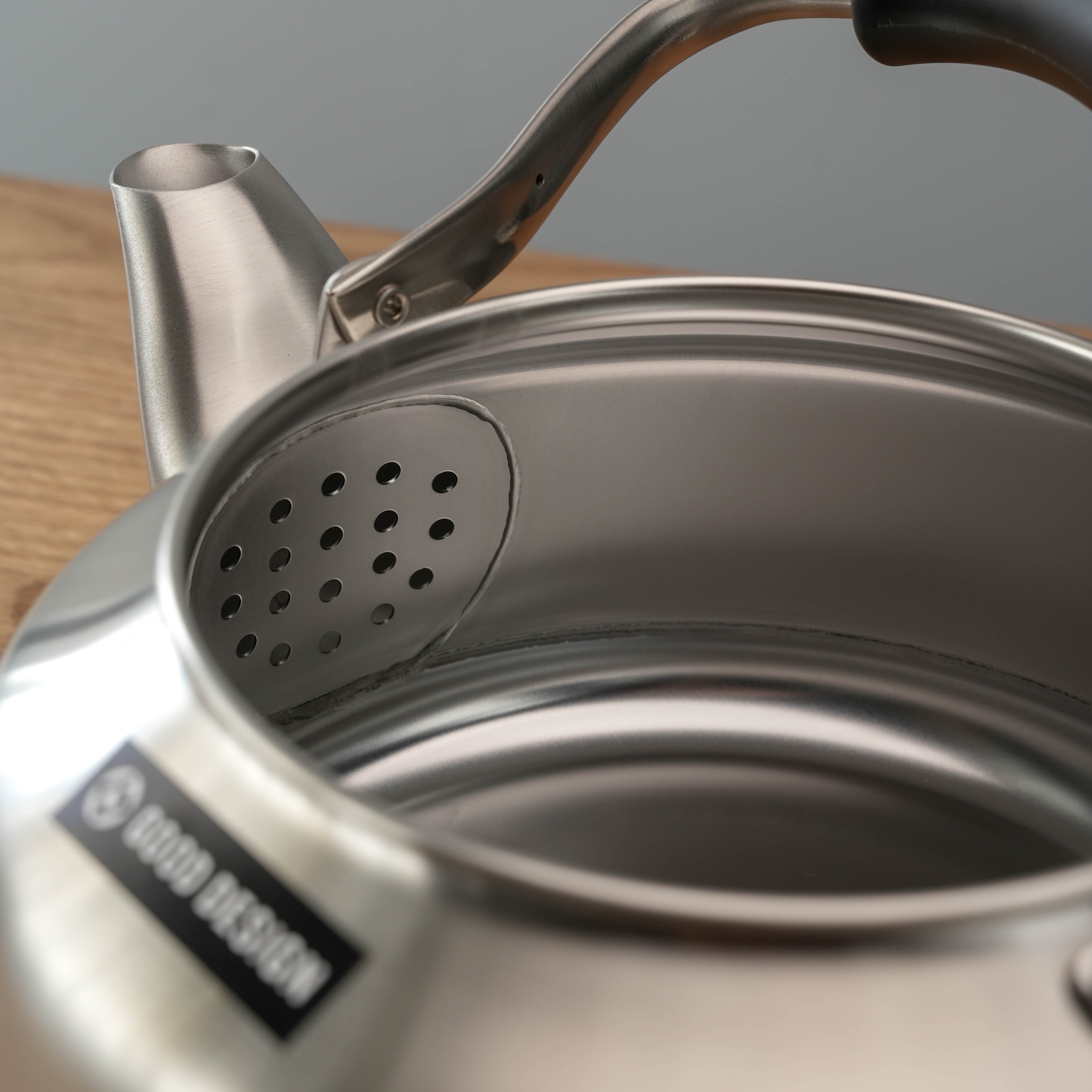Interior view of Sori Yanagi Stainless Steel Kettle showing built-in strainer and seamless brushed steel craftsmanship.