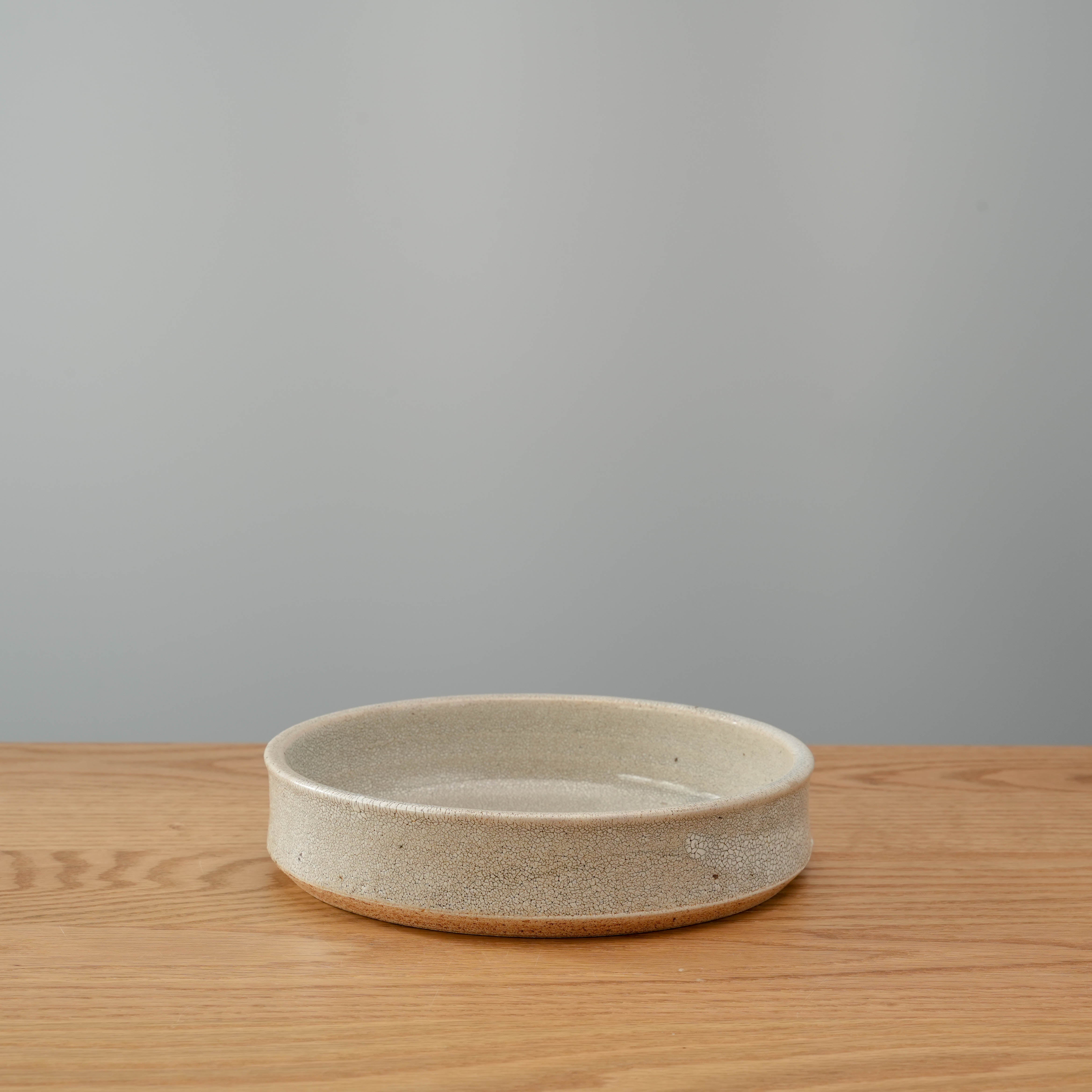 Mino Ware Sabi Kairagi Bowl with rustic Japanese design, featuring a straight-edge form and unique textured glaze on a wooden surface.