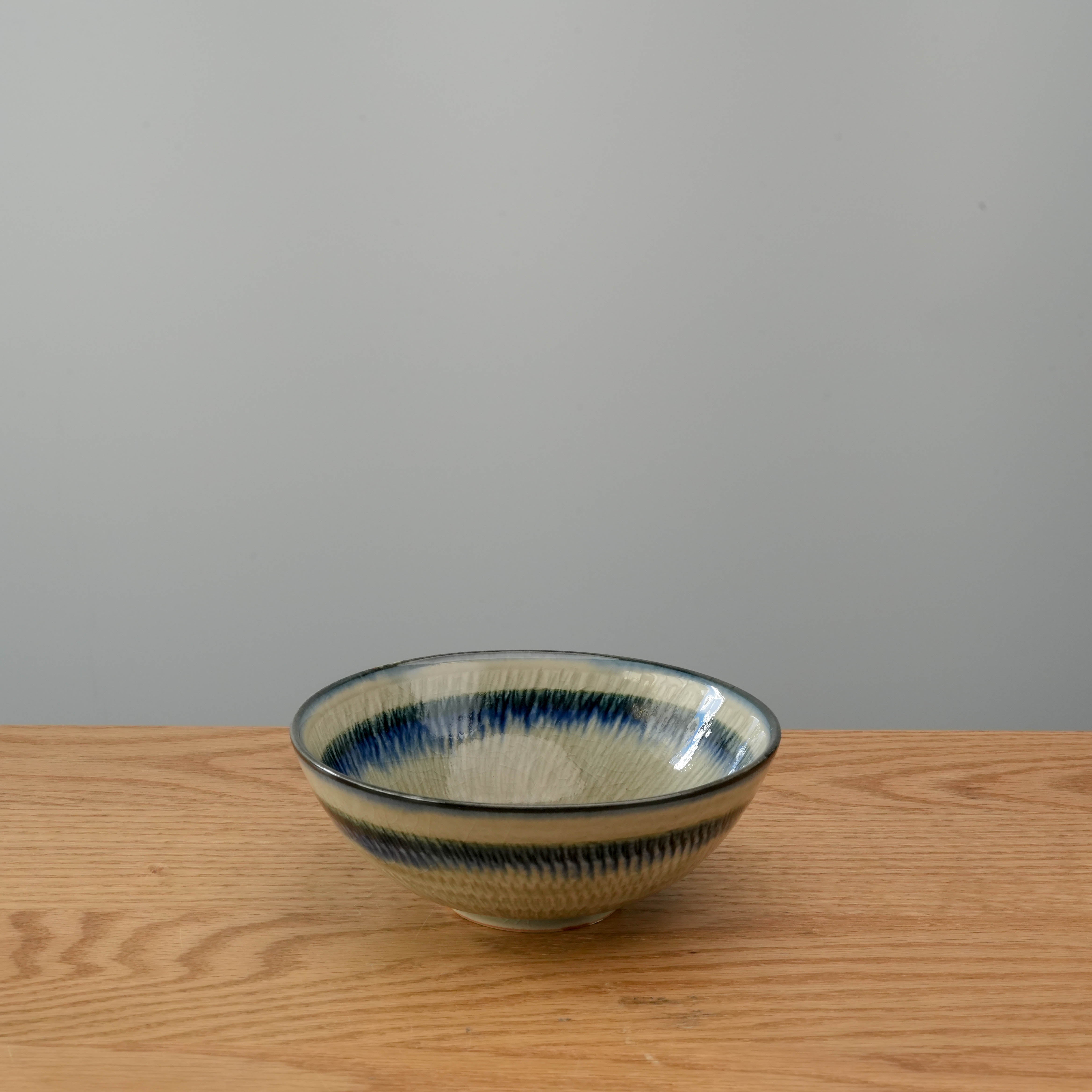 Mino Ware Bowl with classic Ofuke-glaze, featuring a handcrafted Japanese design ideal for serving soups or salads on wooden dining surfaces.