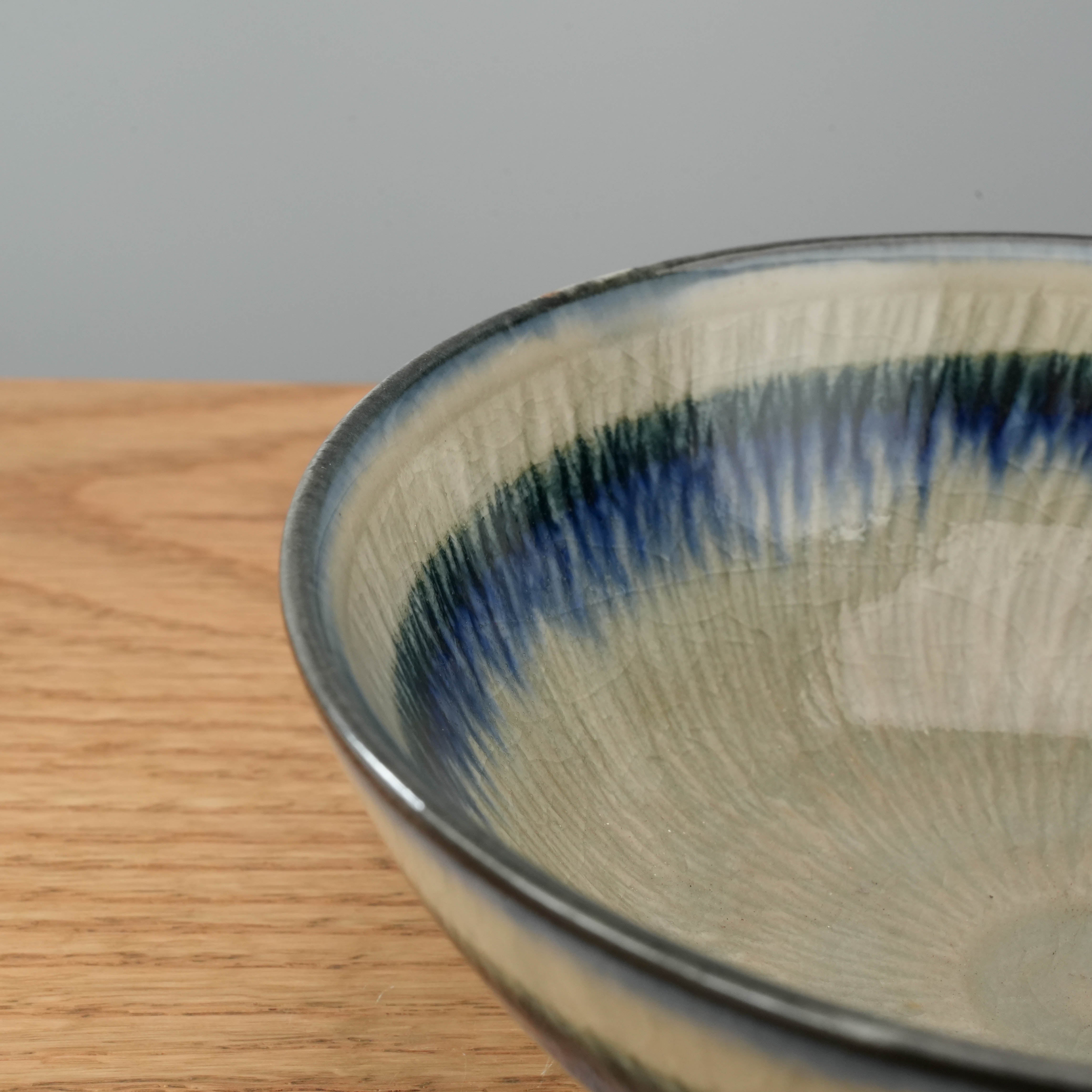 Close-up of Japanese Mino Ware Bowl showcasing shimmering Ofuke-glaze with intricate brush textures, perfect for elegant table settings.
