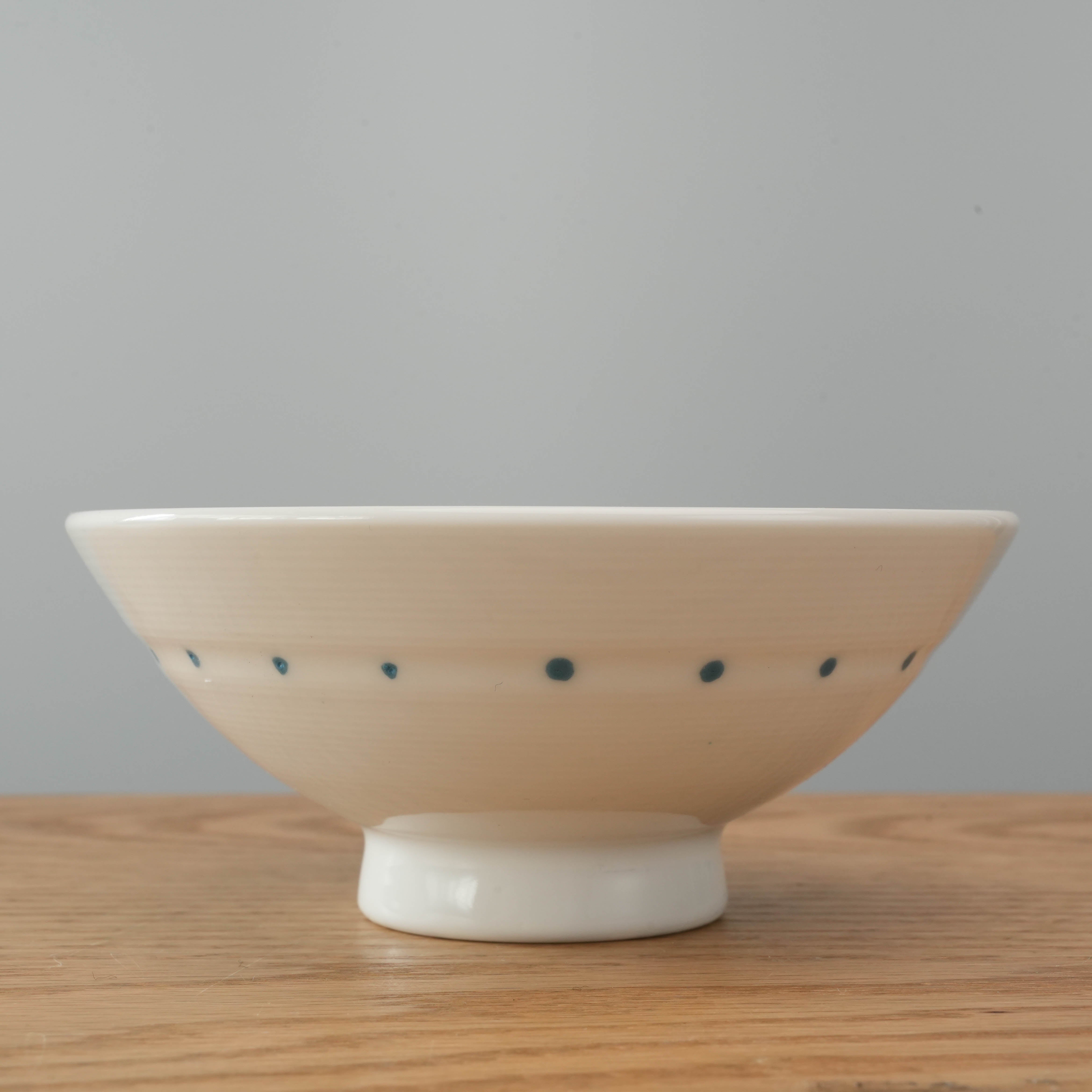 Close-up of Mino Ware Polka Dot Line Rice Bowl showcasing elegant blue dot pattern and traditional Japanese craftsmanship in porcelain.