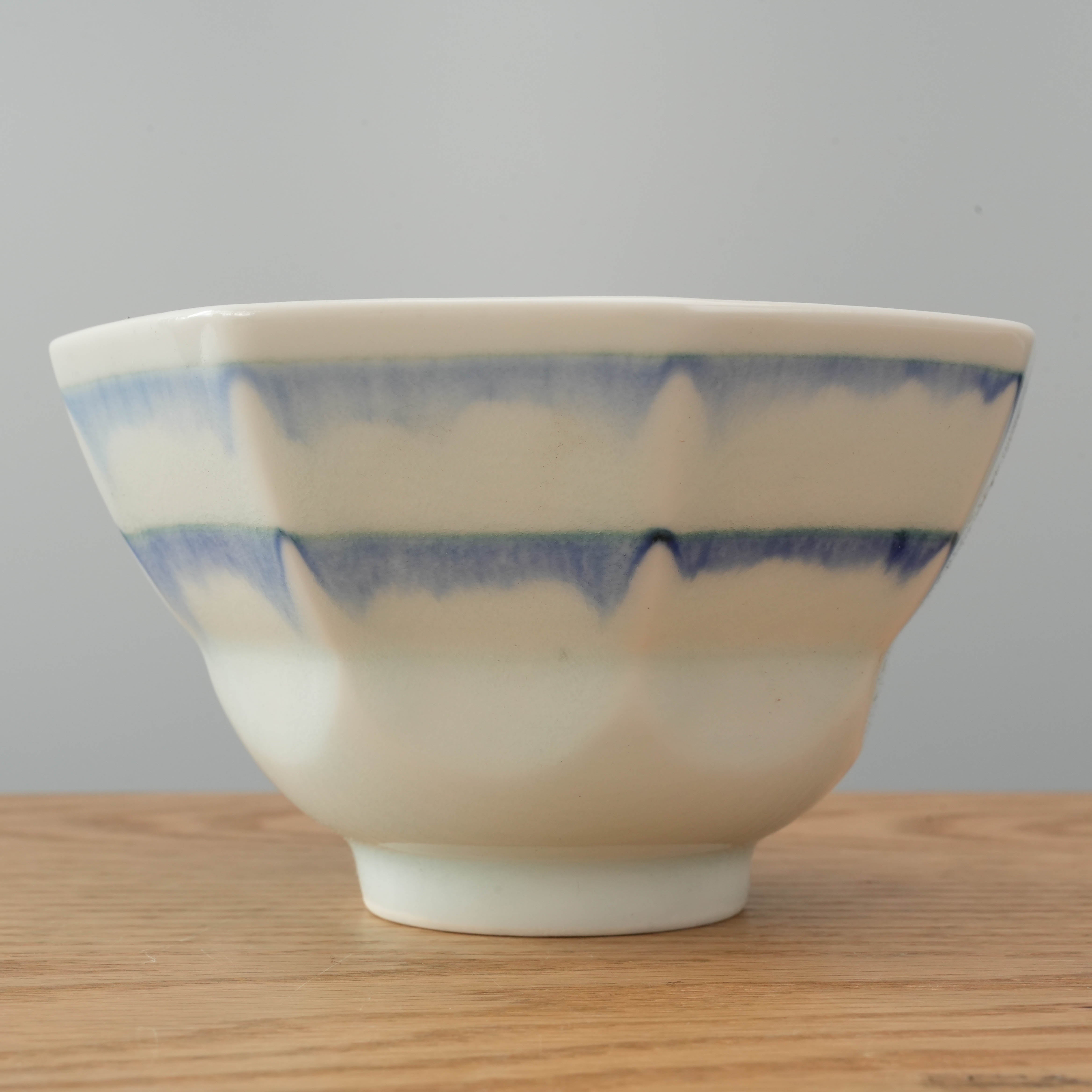 Side view of Indigo Glaze Octagonal Bowl showcasing the elegant layered blue glaze on smooth ceramic, perfect for modern tableware collections.