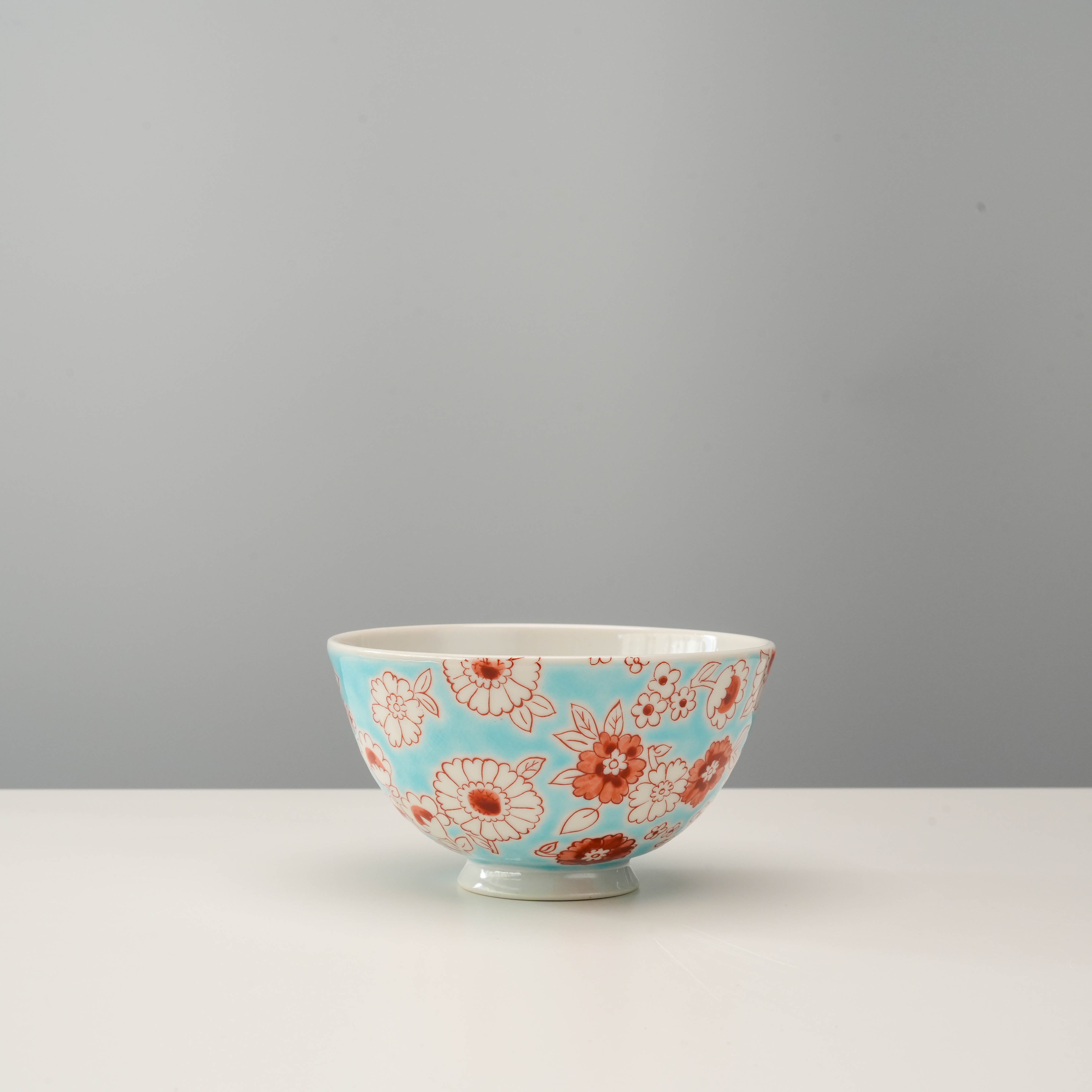Flower Shower Kutani Rice Bowl with red floral pattern on light blue porcelain, ideal for serving rice or side dishes in elegant table settings.