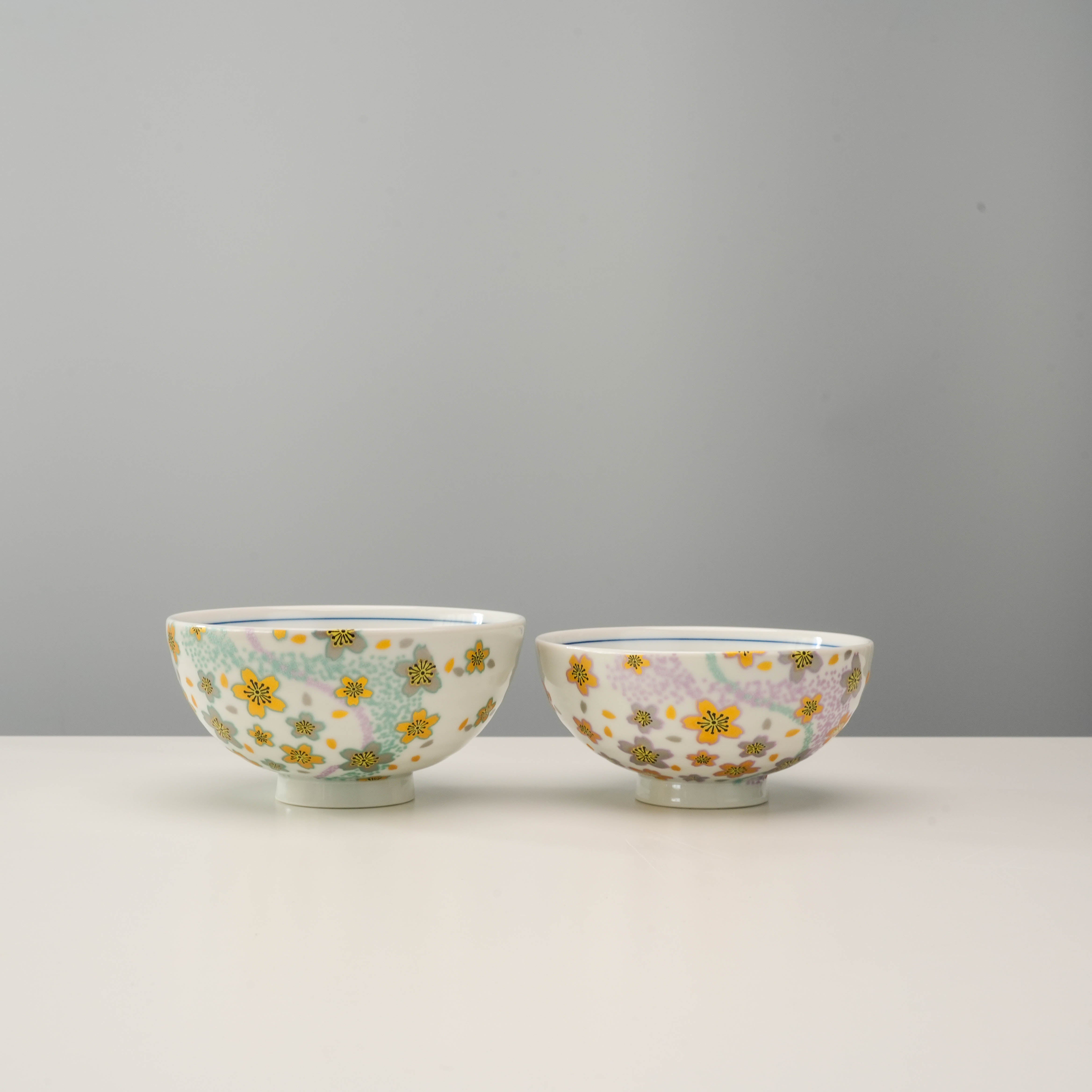 Kyokusui Flower Rice Bowl Set featuring two Kutani Ware bowls with pastel floral patterns, ideal for gifting or elegant dining decor.