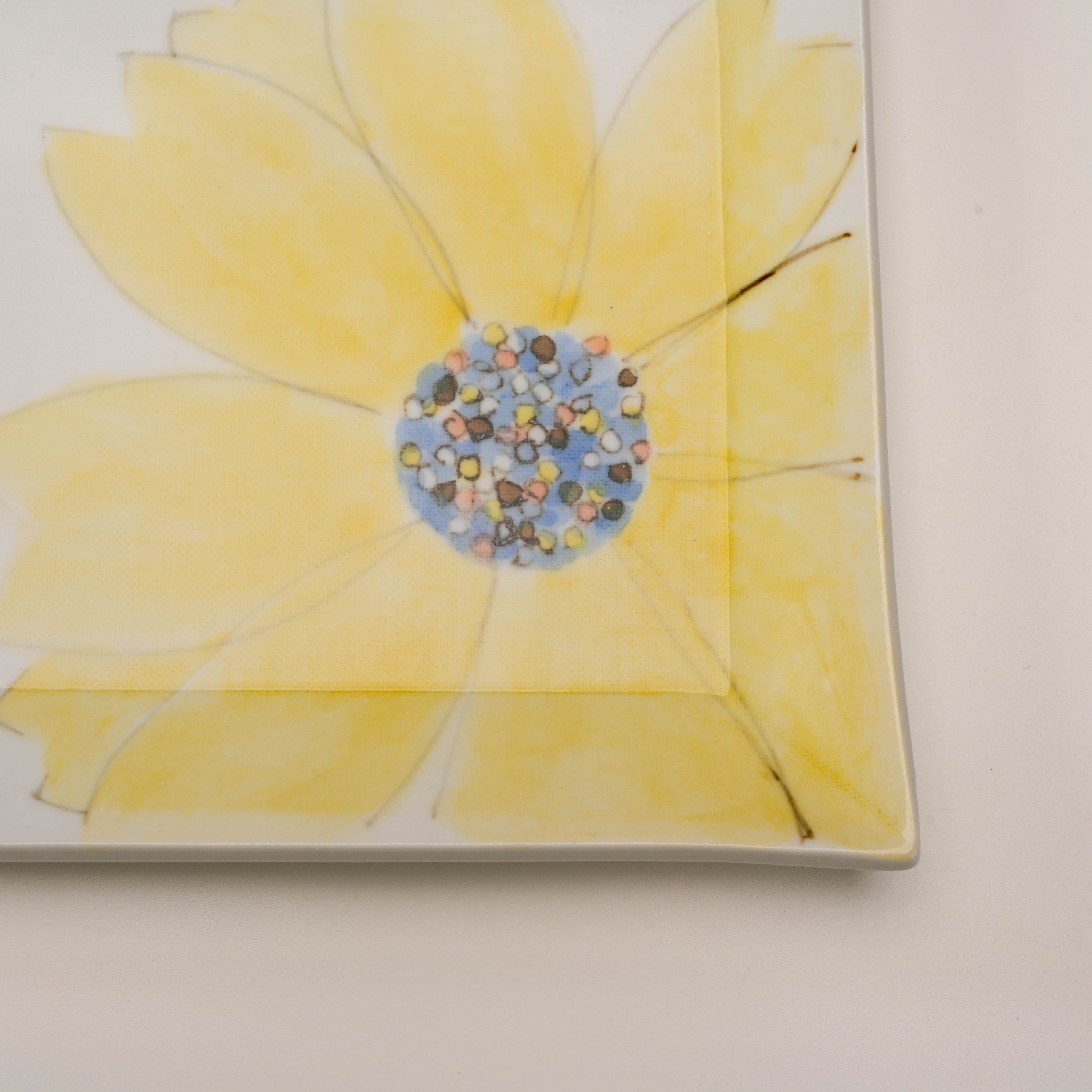Close-up of Kutani Ware Serving Plate featuring a yellow petal bloom with intricate hand-painted details on a square ceramic surface.