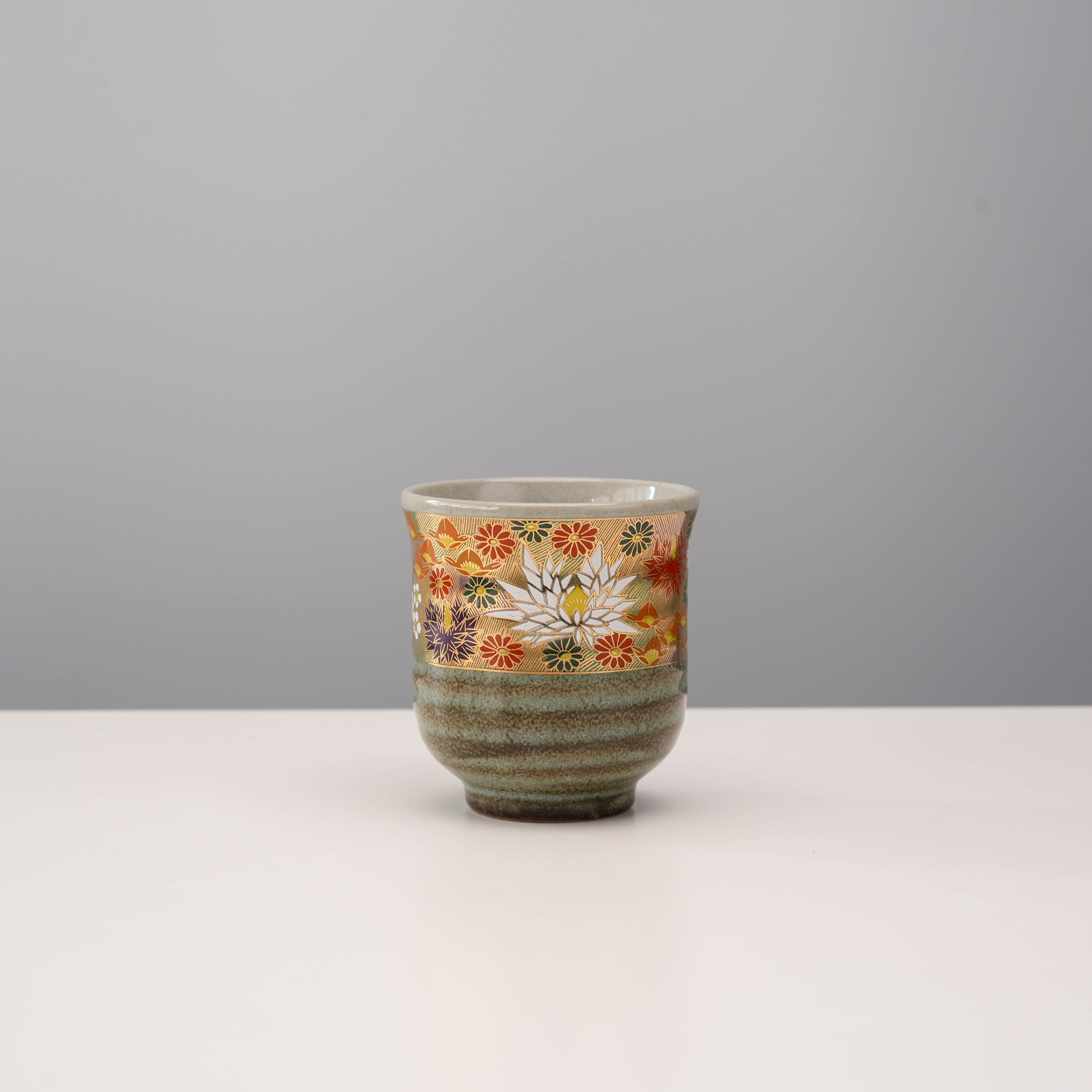 Golden Garden Yunomi Teacup - Handcrafted Kutani with gold leaf floral patterns and earthy green glaze, ideal for elegant tea settings.
