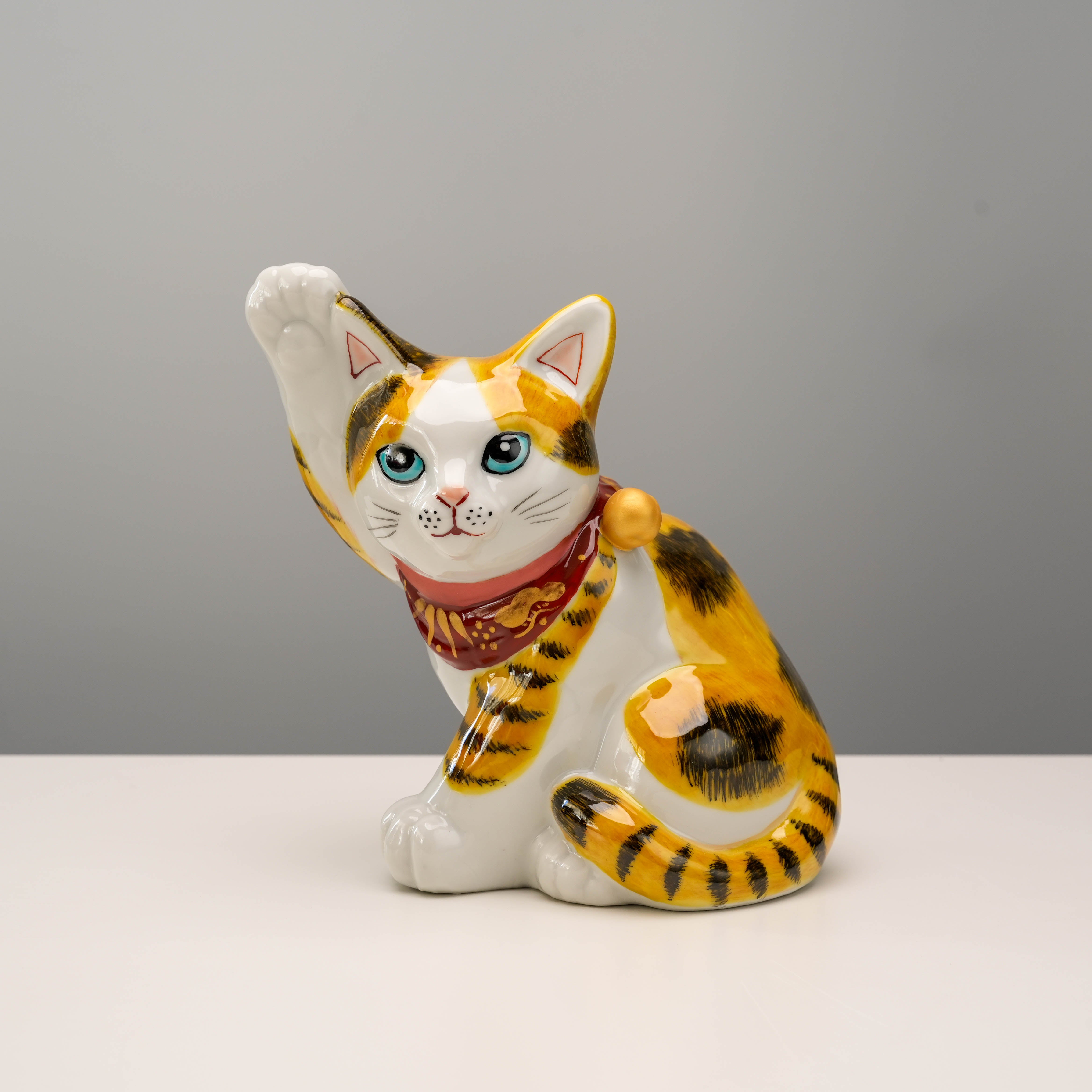 Kutani Ware Cat Ornament - Lucky Cat in Aokutani style with calico coat and blue eyes, ideal for home decor or gift display.