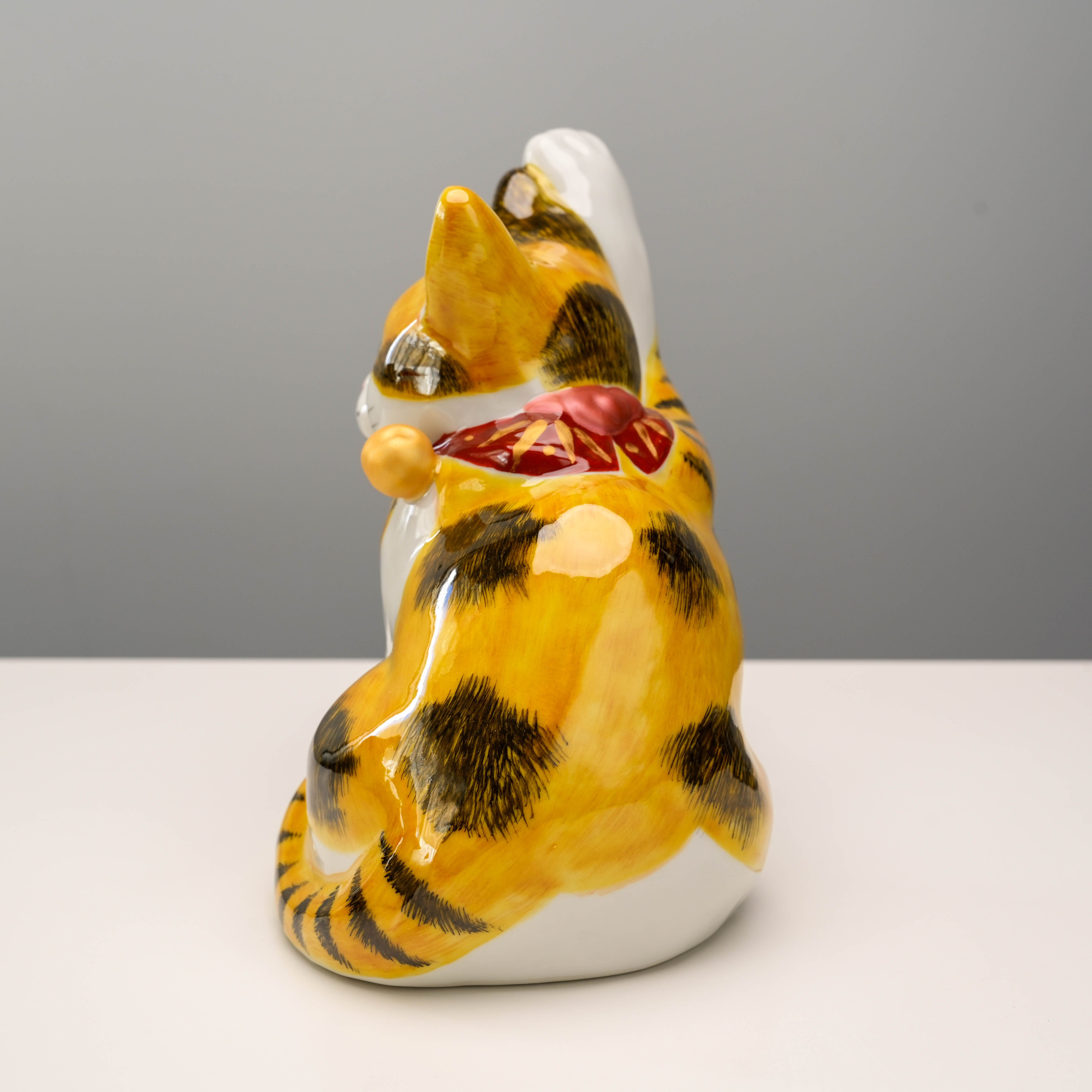 Back view of Kutani Ware Cat Ornament - Aokutani Calico style, showcasing hand-painted fur pattern and red scarf detail.