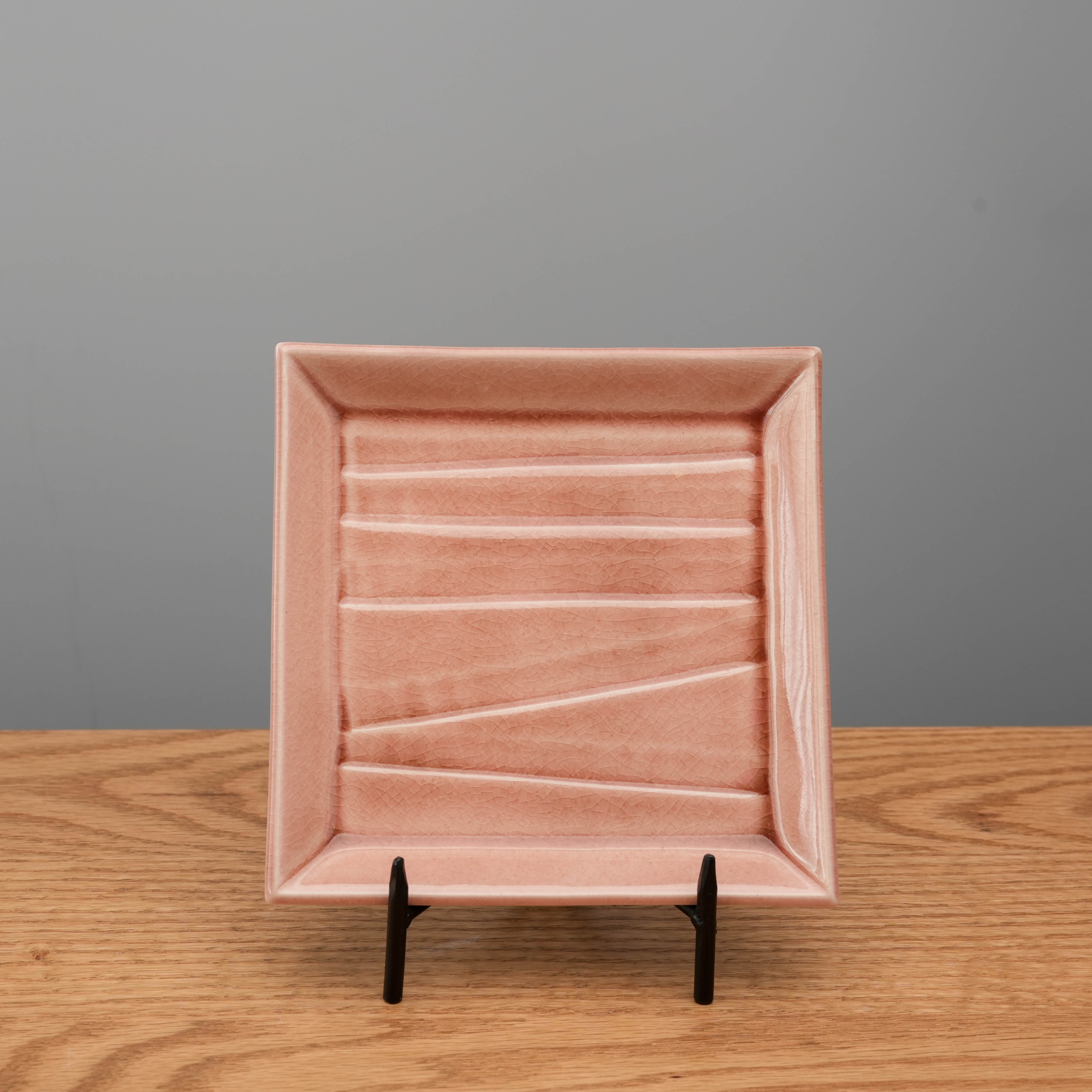 Mino Ware Crackle Glaze Rose Pink Square Plate displayed upright on a stand. Elegant for serving desserts or sushi in modern dining settings.