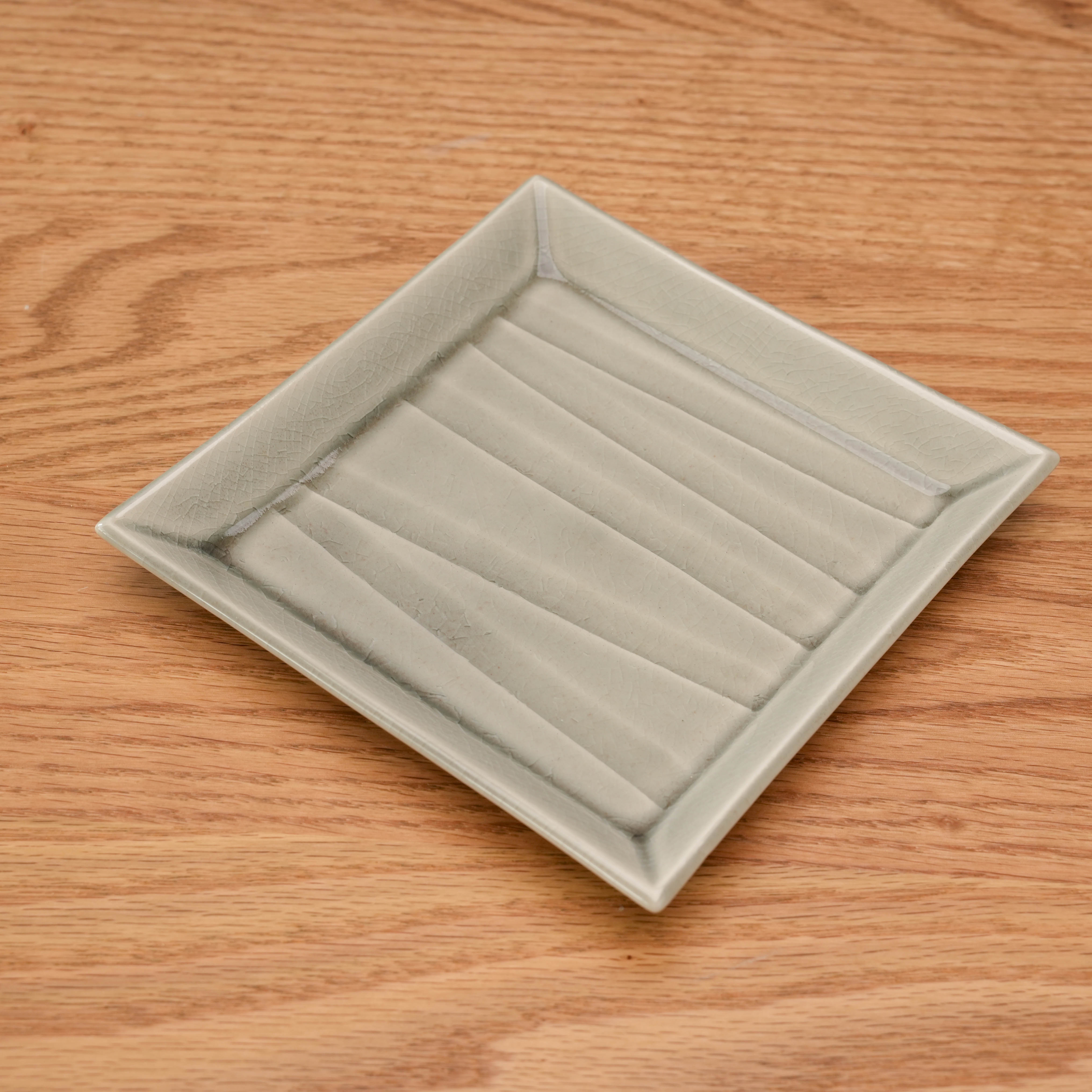 Mino Ware Crackle Glaze Grey Square Plate shown at an angle. Elegant dinnerware with textured glaze, perfect for modern table settings.