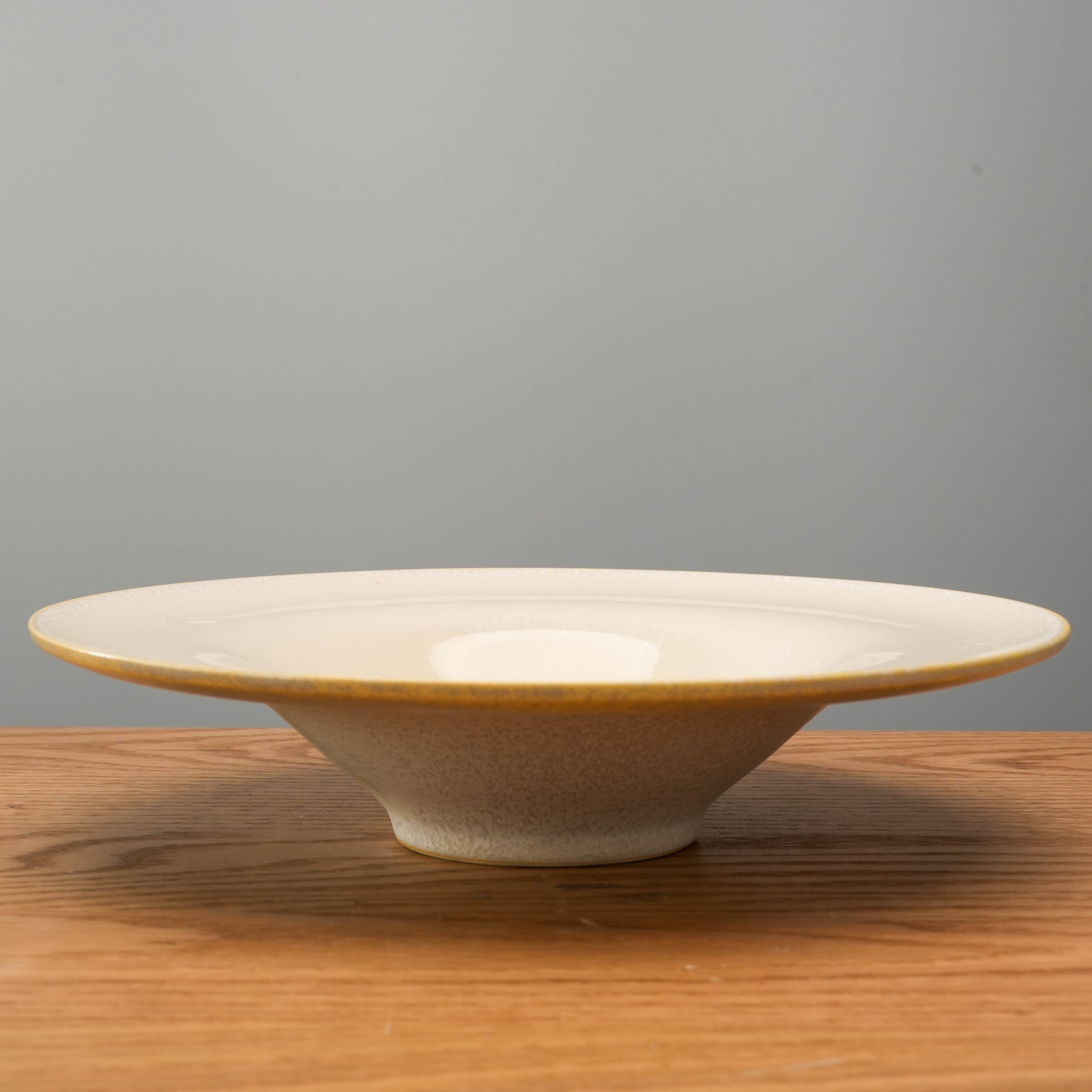 Side view of Mino Ware White Glass Hat Bowl 24cm highlighting its flared rim and elevated base, perfect for elegant table settings.