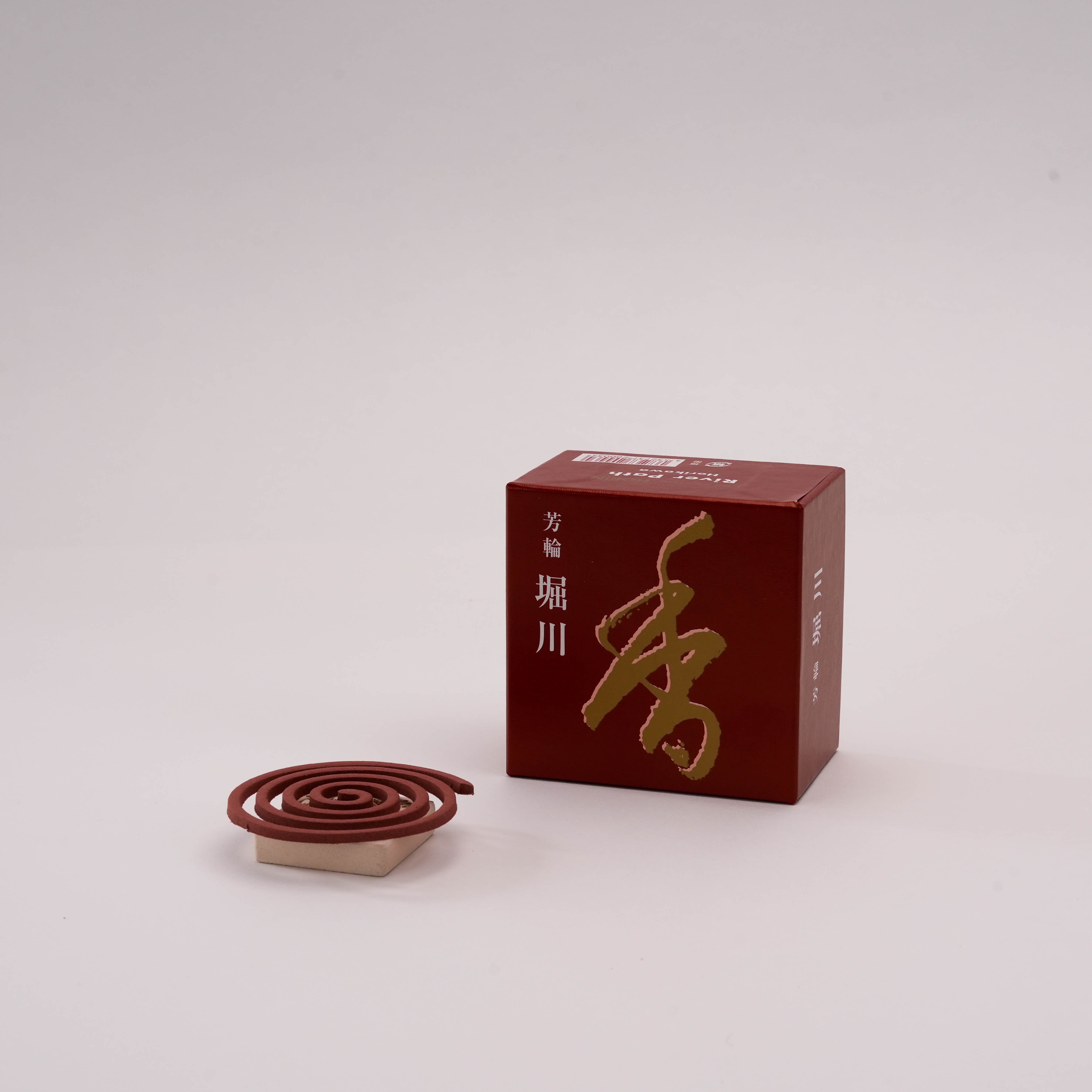 Shoyeido Horin Incense - River Path coil with holder, offering a sweet sandalwood aroma inspired by Kyoto's tranquil river path.