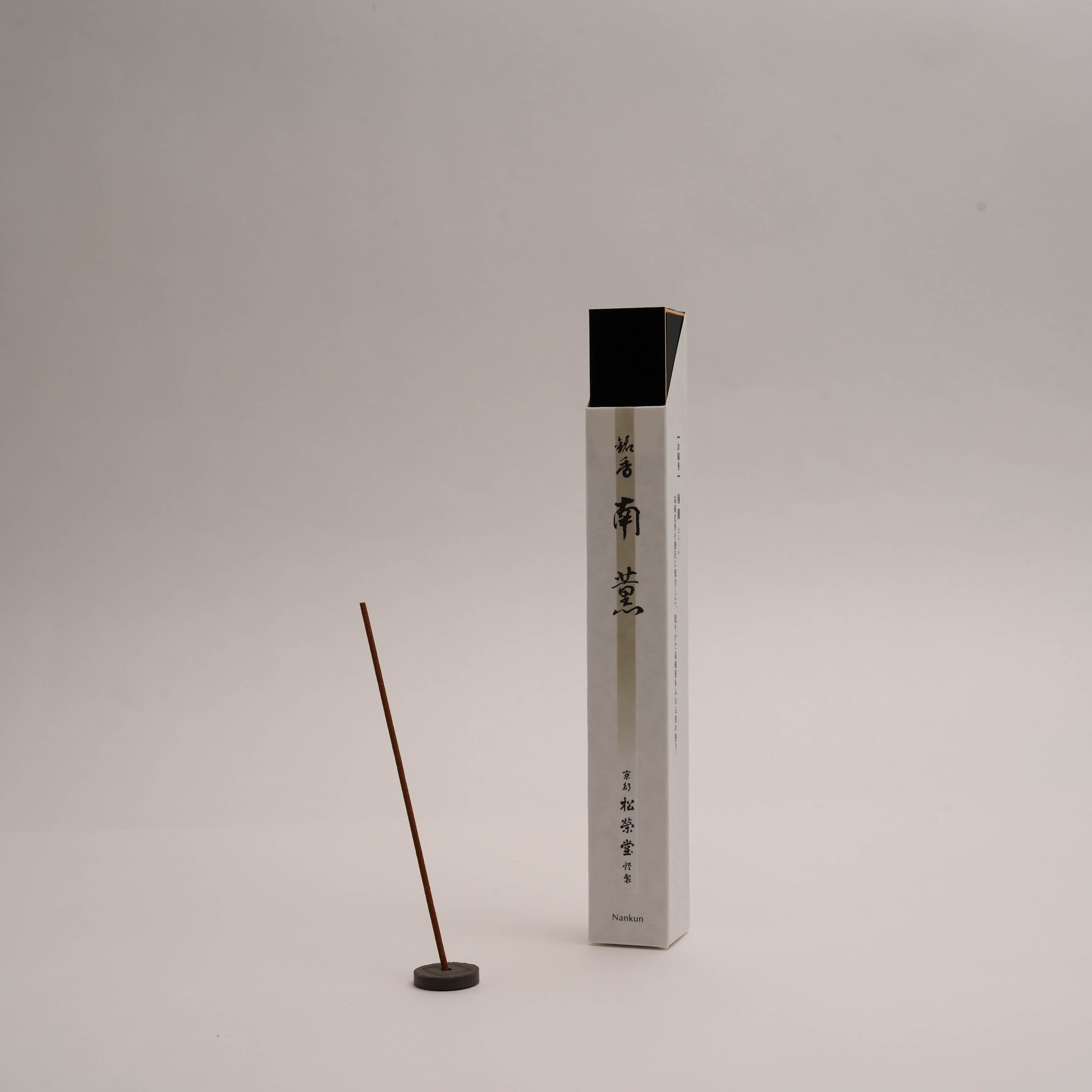 Shoyeido Premium Incense - Southern Wind displayed with a single lit incense stick and holder, ideal for tranquil home fragrance and meditation.