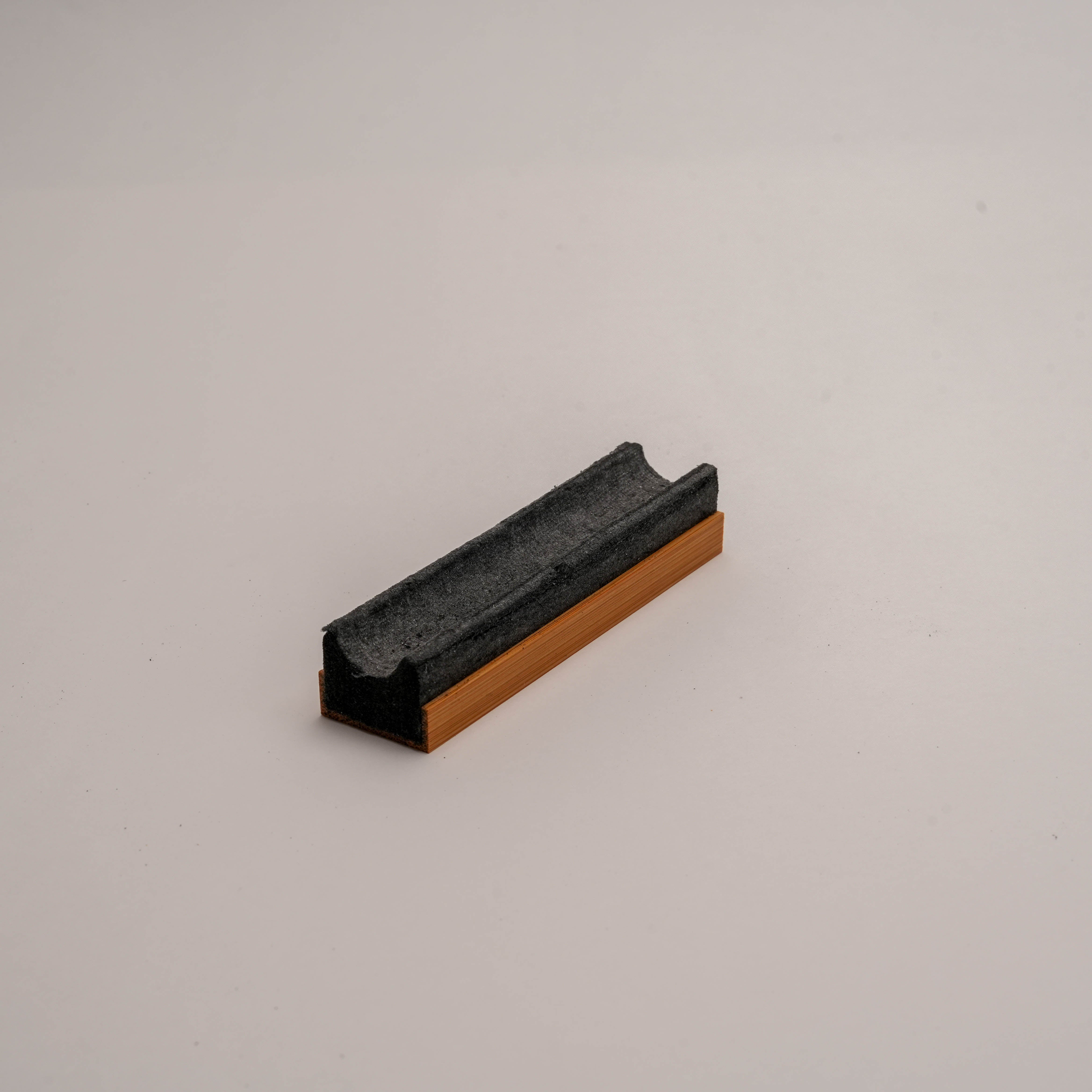 Compact view of Shoyeido Takuba incense holder showcasing its sleek bamboo and felt design for clean incense burning.