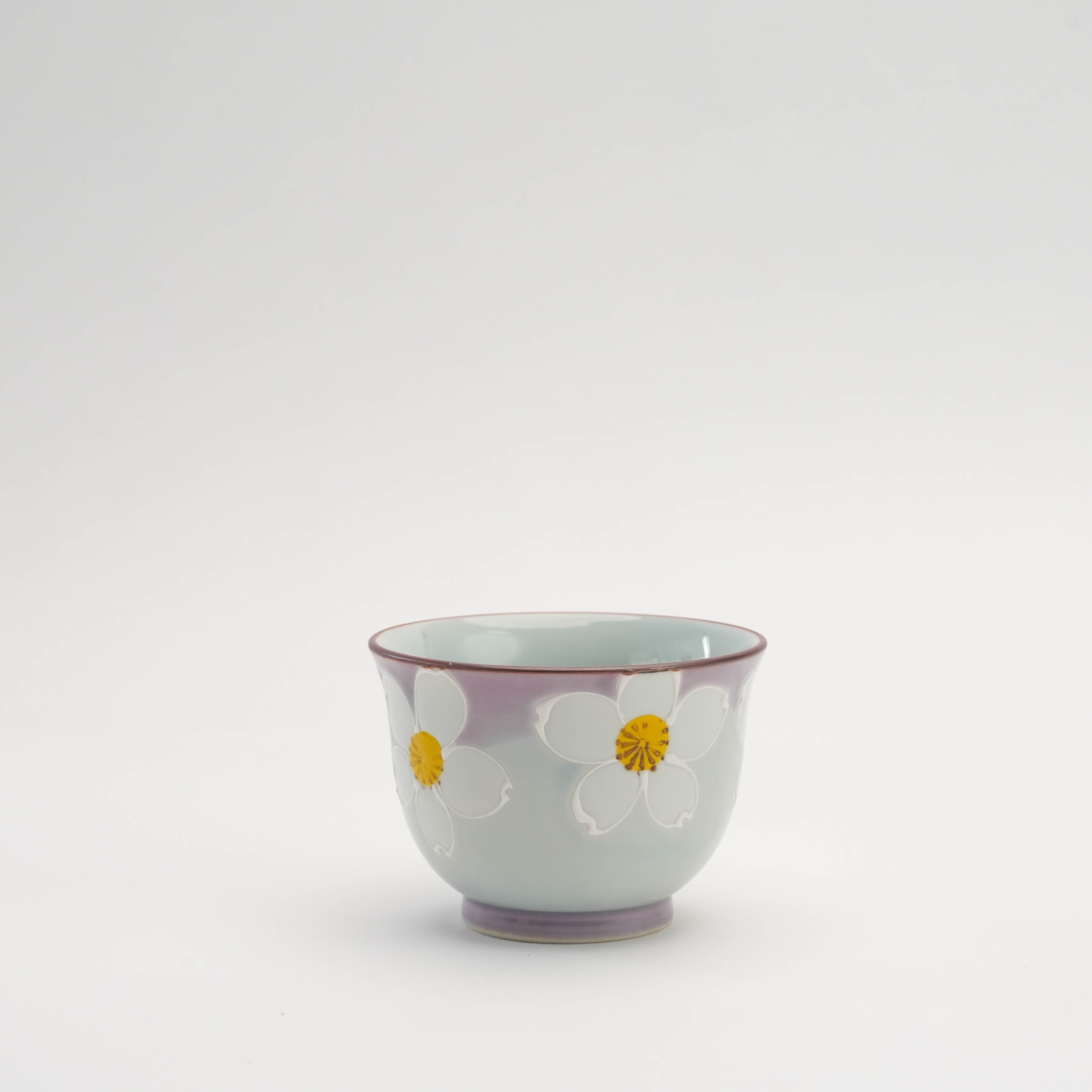Urara Sakura Tea Cup - Arita Ware with hand-painted white sakura flowers and purple gradient rim, perfect for elegant tea service.