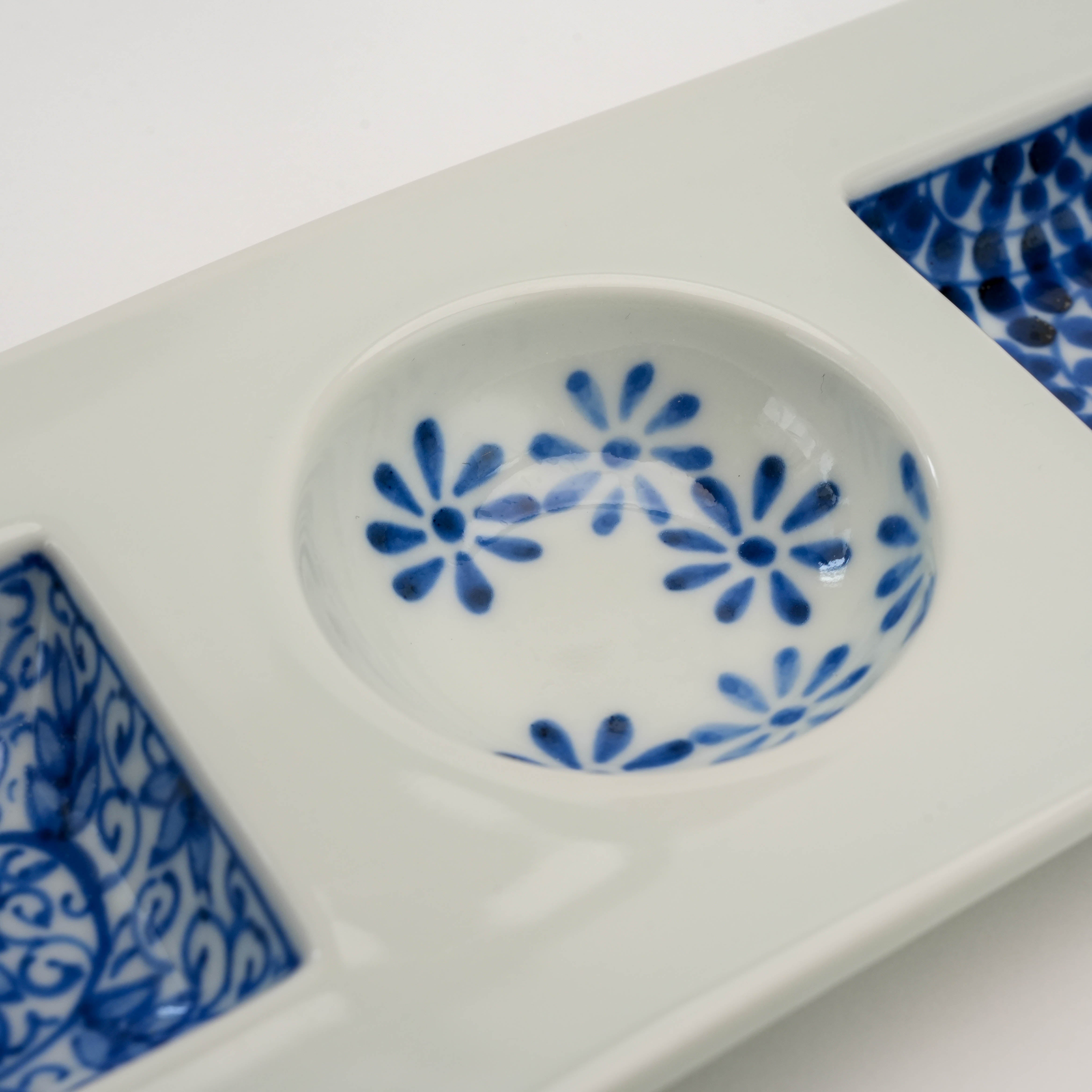 Floral pattern detail in round center compartment of Arita Ware Sometsuke Triple Dish, perfect for sauces or small bites.