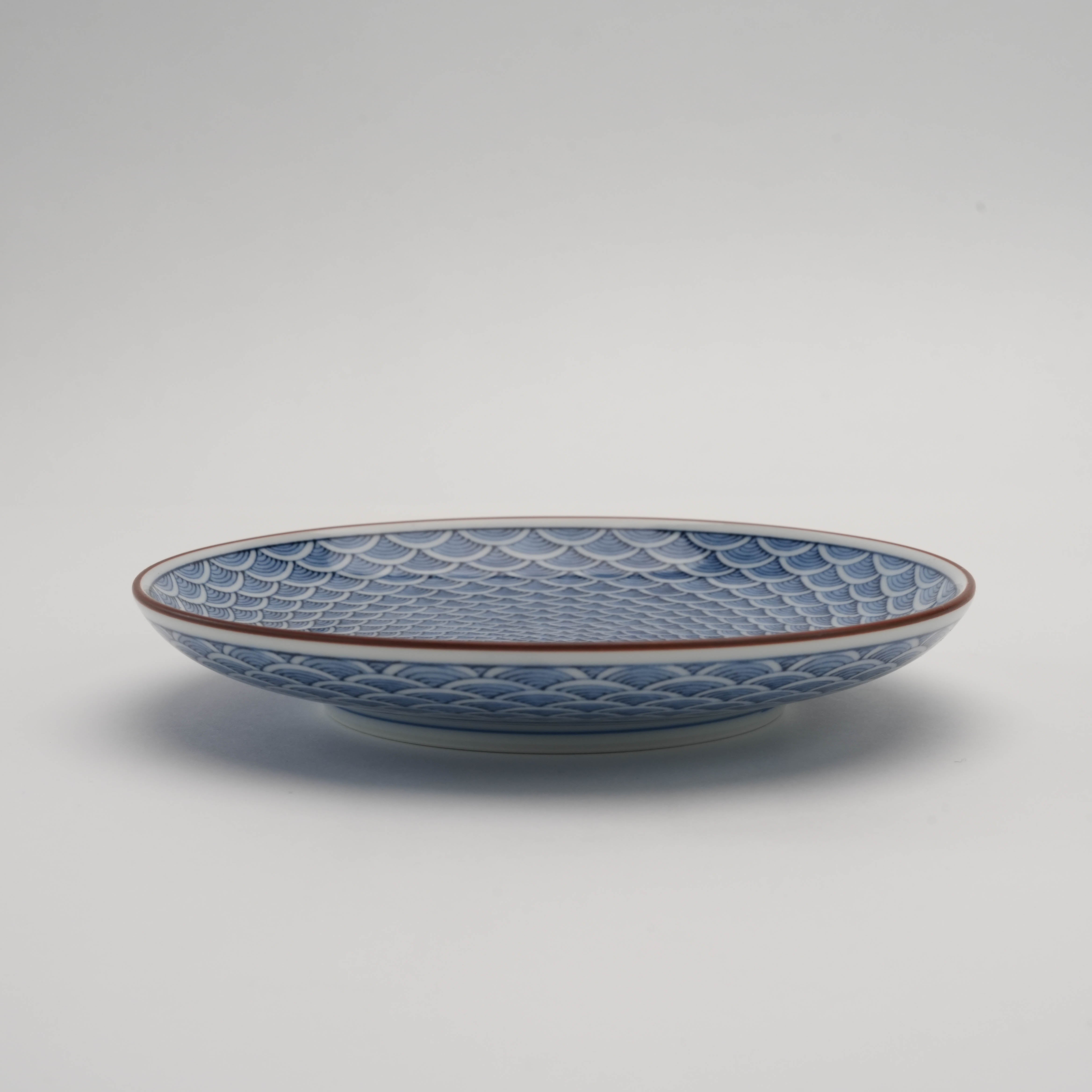 Side view of Arita Ware Seigaiha Small Plate highlighting its shallow depth and detailed wave motif, ideal for elegant table settings or display.