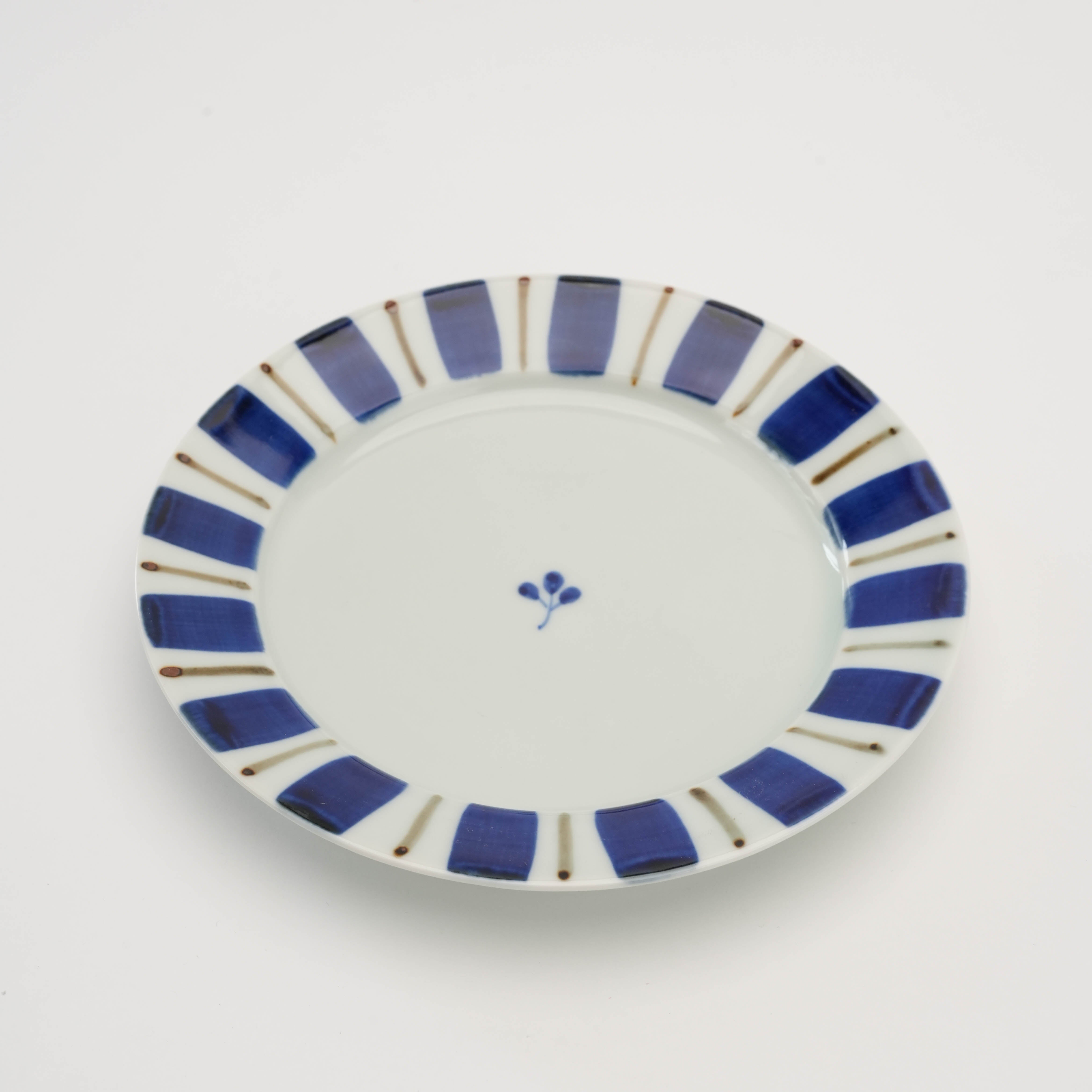 Top view of Arita Gosu Plate - Tokusa Design φ15.5cm showing hand-painted blue stripes and central floral motif, perfect for appetizers.