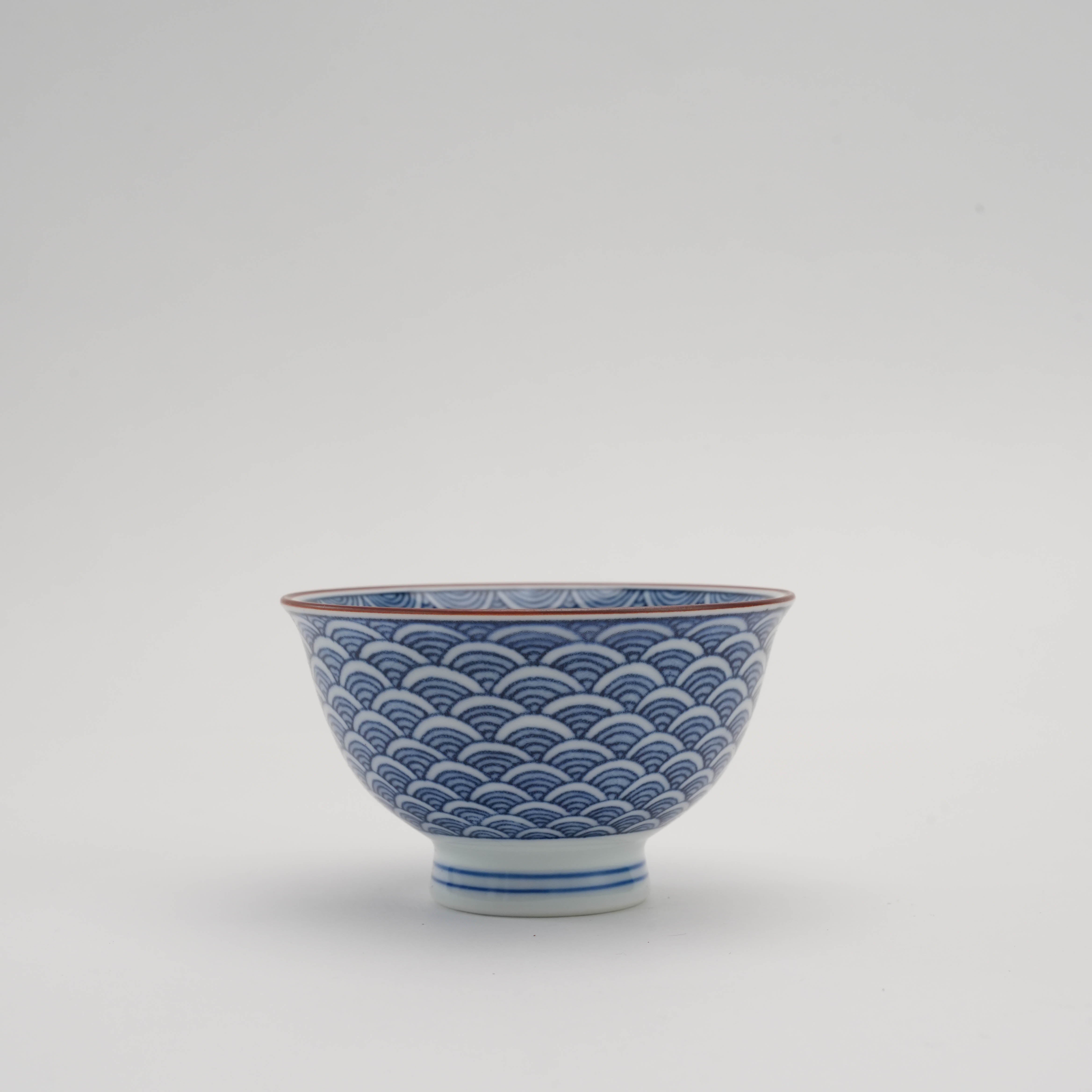 Arita Ware Tea Cup with Seigaiha design featuring hand-painted blue wave patterns on white porcelain, ideal for sencha tea rituals.