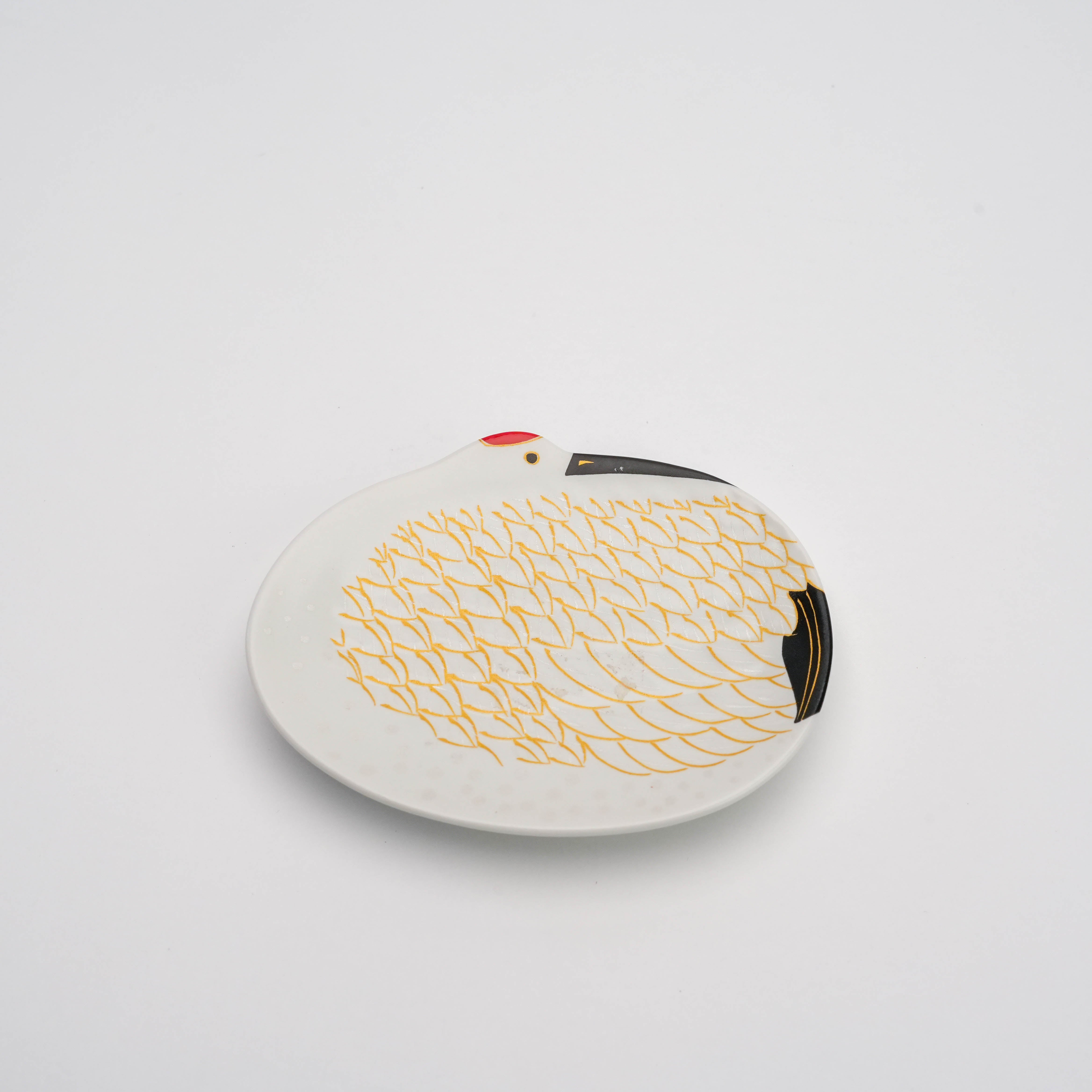 Arita Snow-Covered Crane Dish - Small Gold Feather features a white porcelain dish shaped like a crane with gold feather detailing. Ideal for elegant serveware or decor symbolizing longevity.