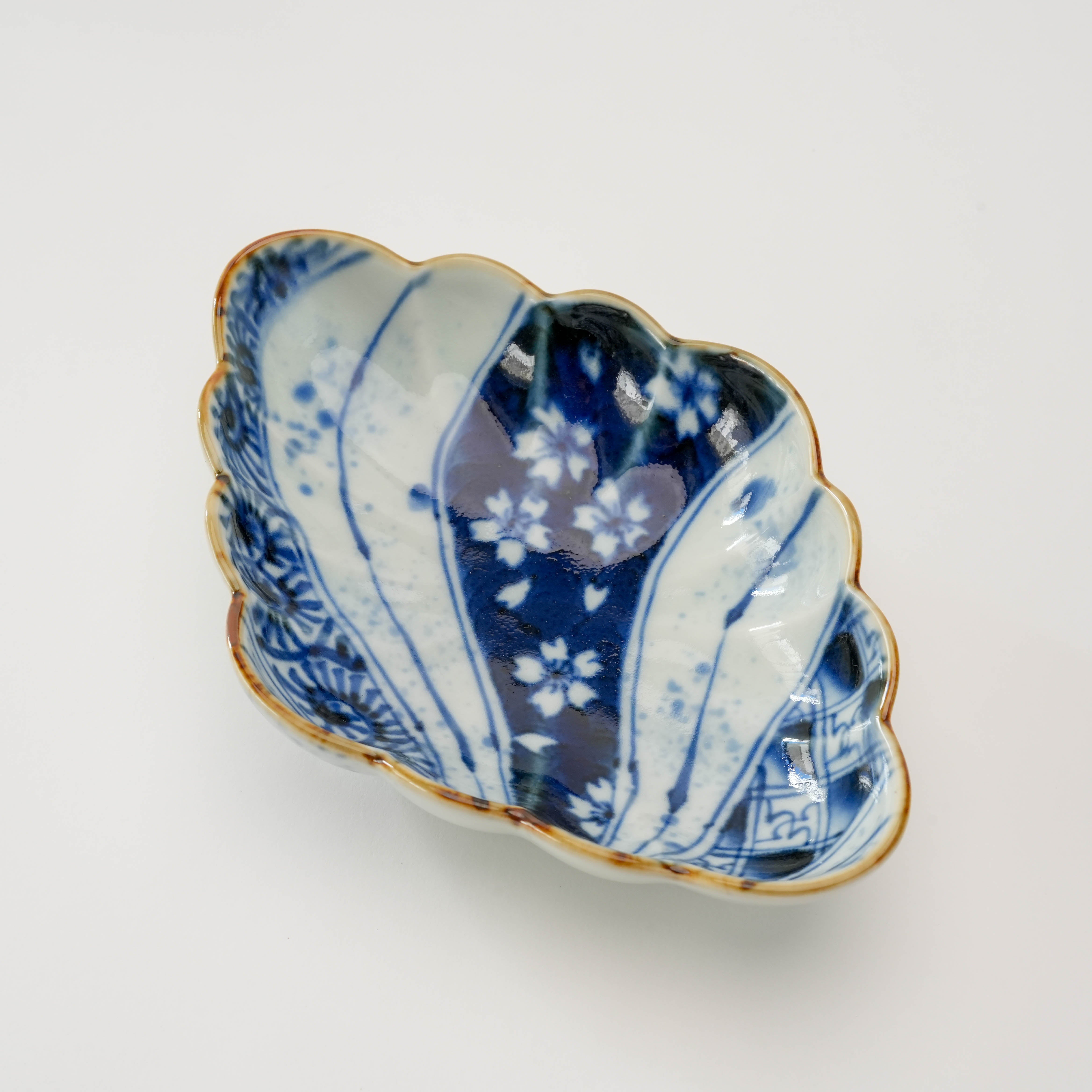 Top view of Arita Ware Diamond Bowl - Fukusen Kiln showing intricate blue floral and wave motifs, perfect for decorative or functional tableware use.