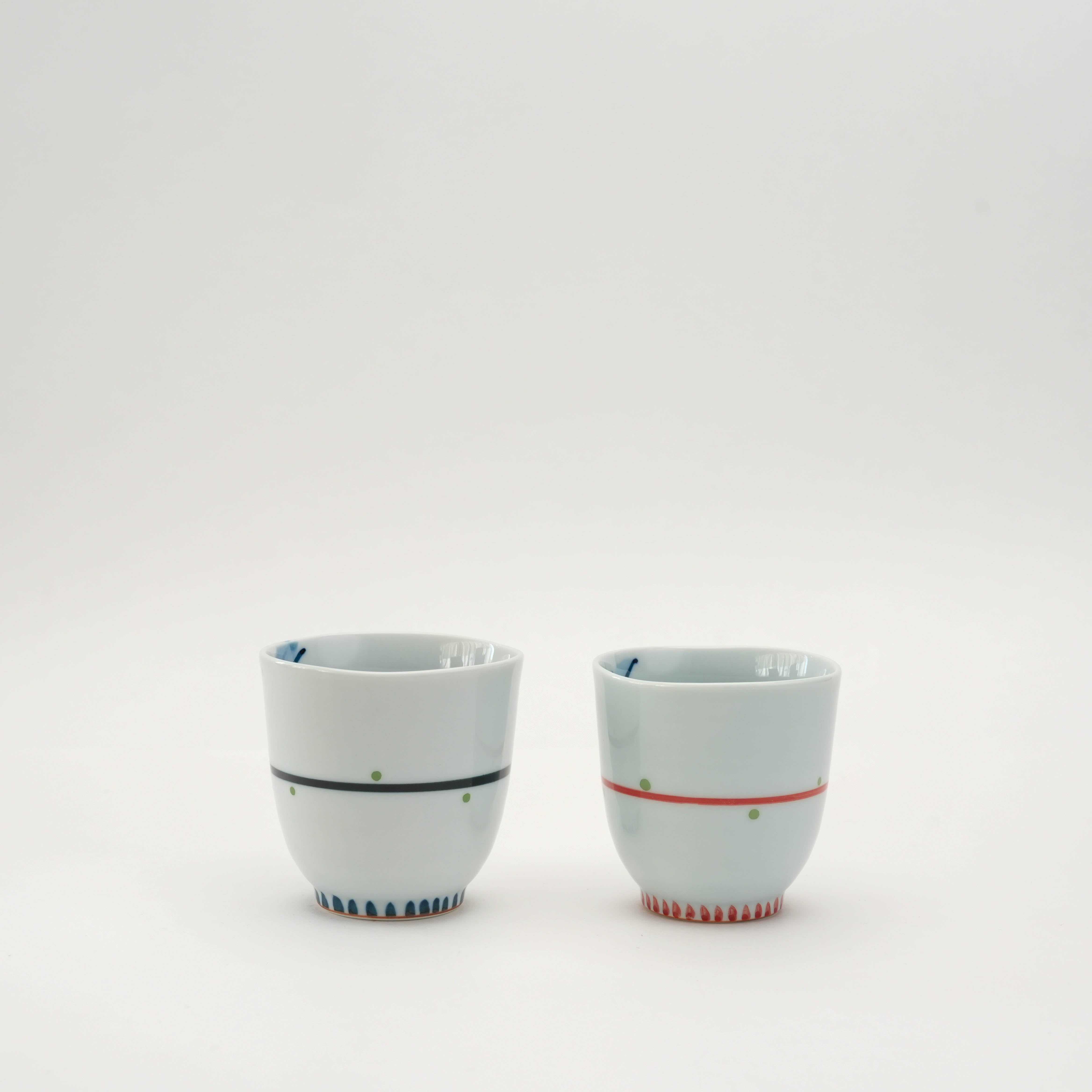 Arita Ware Owl Teacup set in red and blue with minimalist exterior lines and playful owl design hidden inside. Japanese porcelain drinkware.