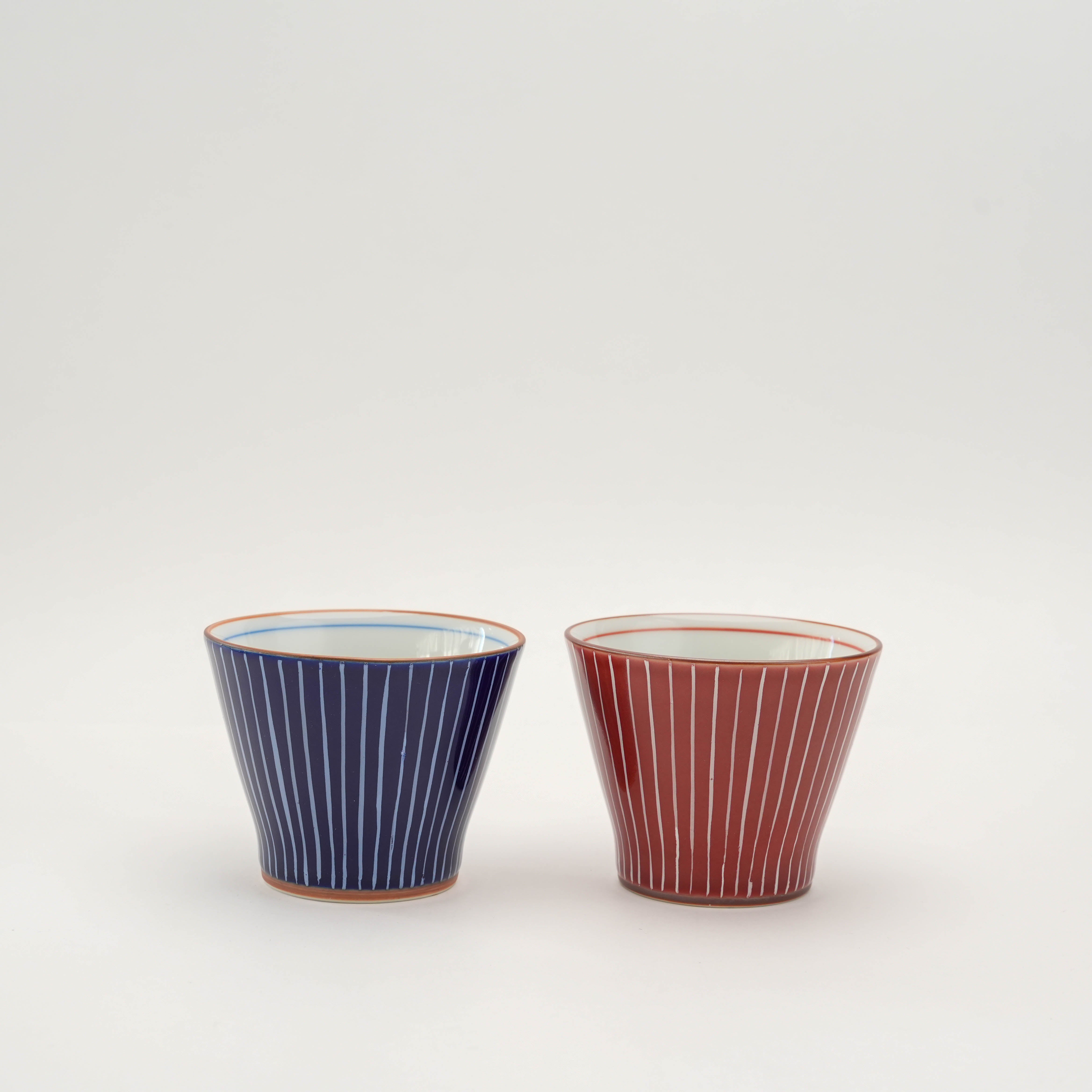 Shiraito Teacup - Japanese Teacup in blue and red with hand-painted vertical lines. Elegant yunomi style for modern drinkware collections.