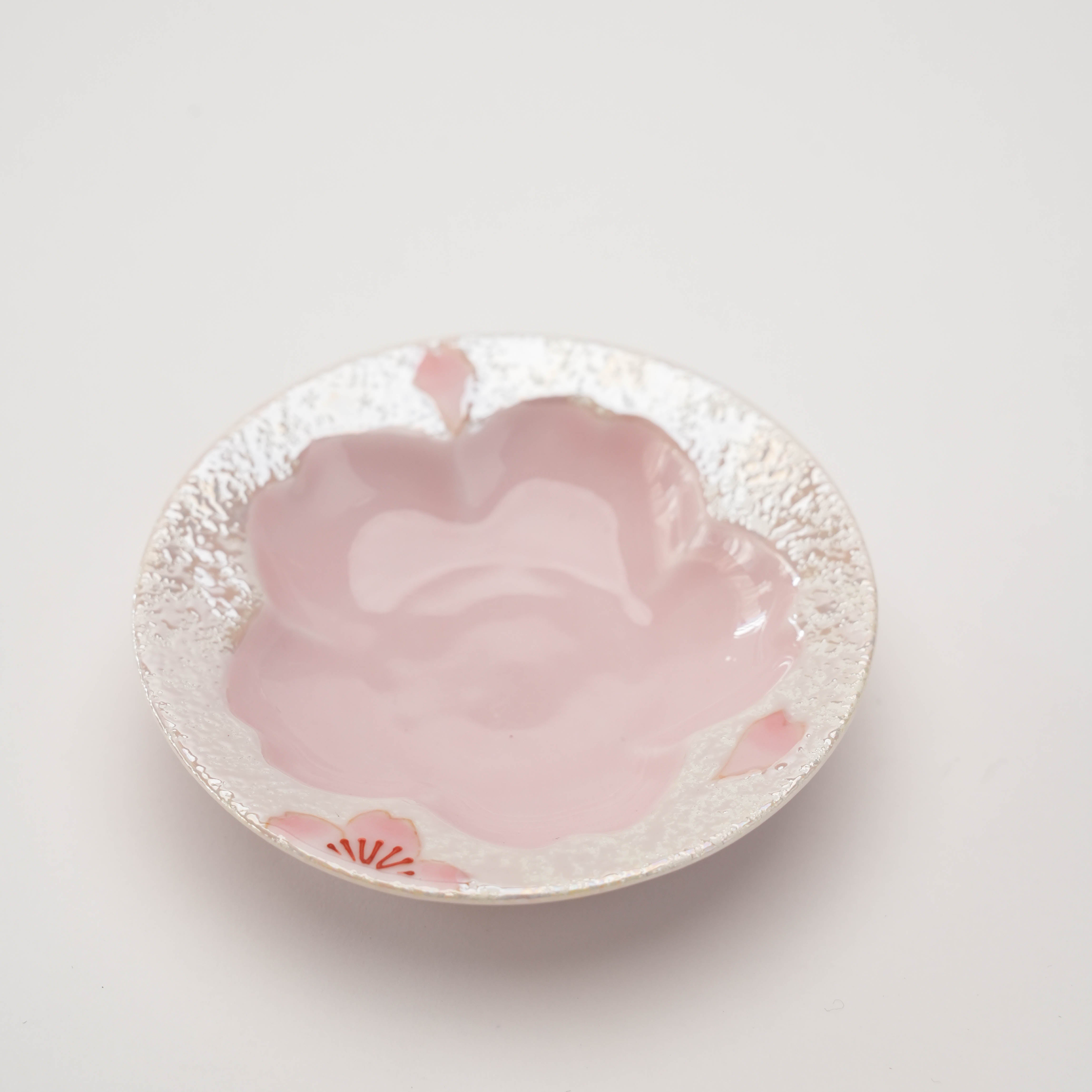 Cherry blossom-themed saucer from Arita Ware Teacup set, featuring a delicate pink floral shape and textured ceramic finish.