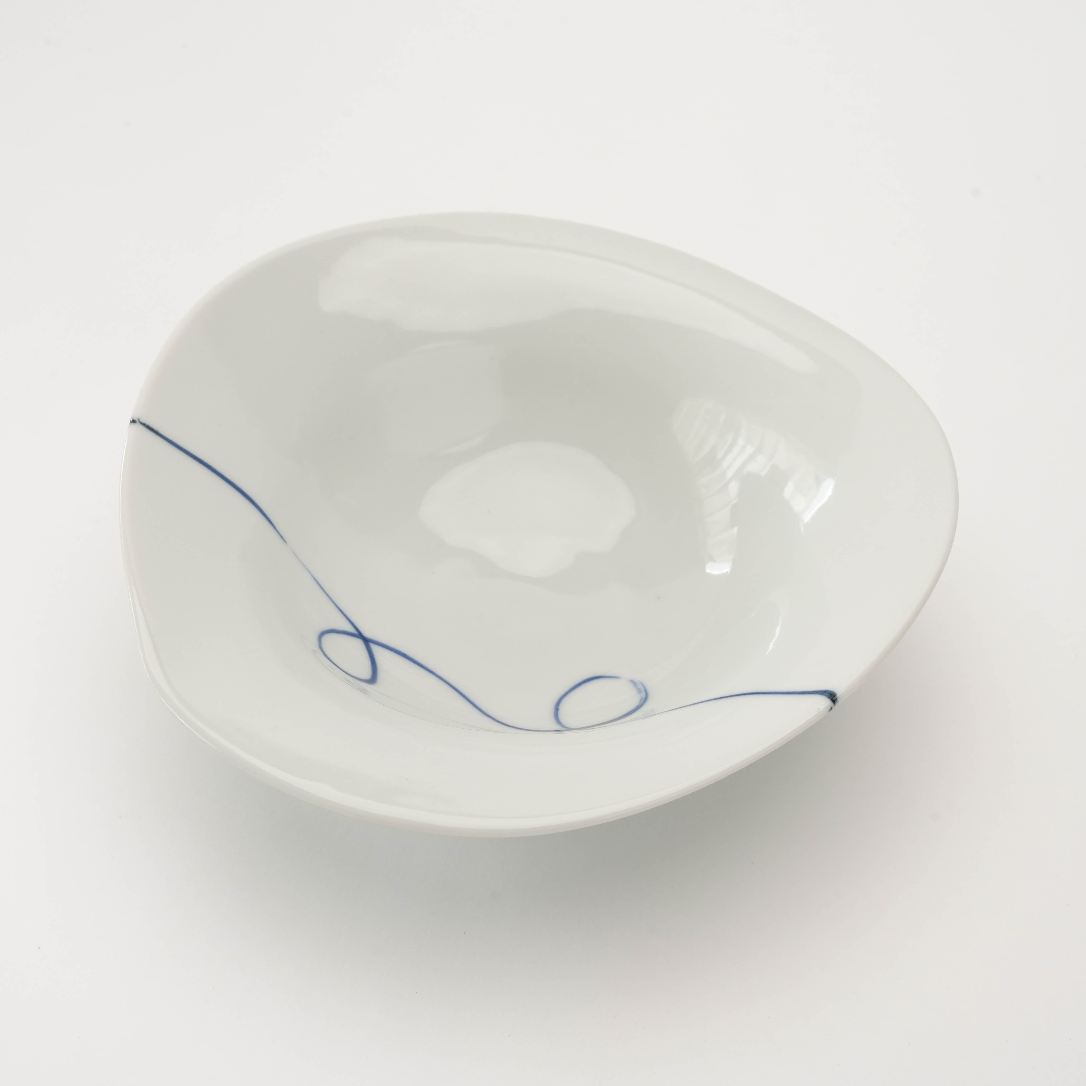 Top view of Arita Ware Twisted Small Bowl showing minimalist hand-painted indigo swirl design on white ceramic, perfect for modern table settings.