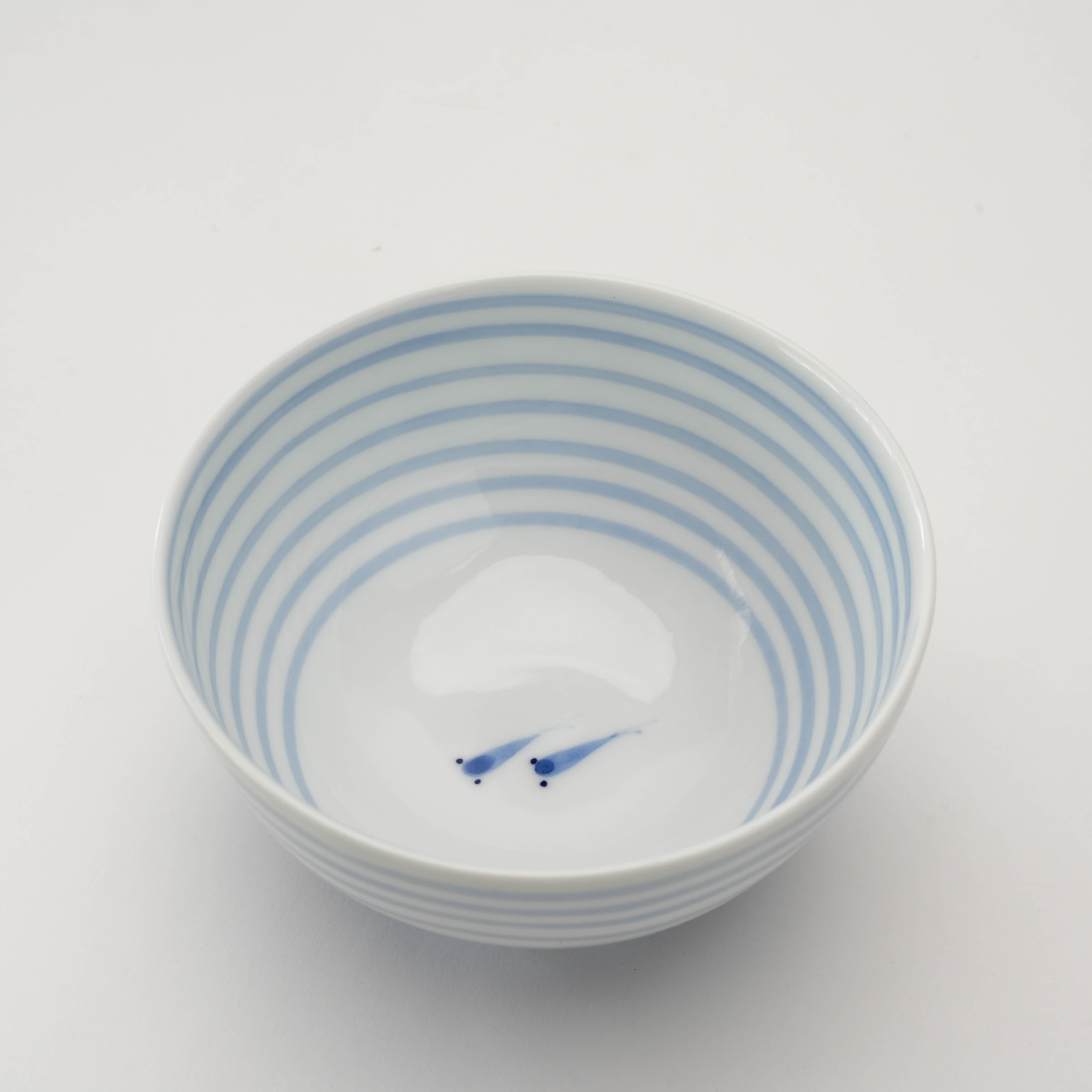 Arita Medaka Rice Bowl with hand-painted medaka fish inside and indigo blue stripes, ideal for elegant table settings and Japanese-style dining.