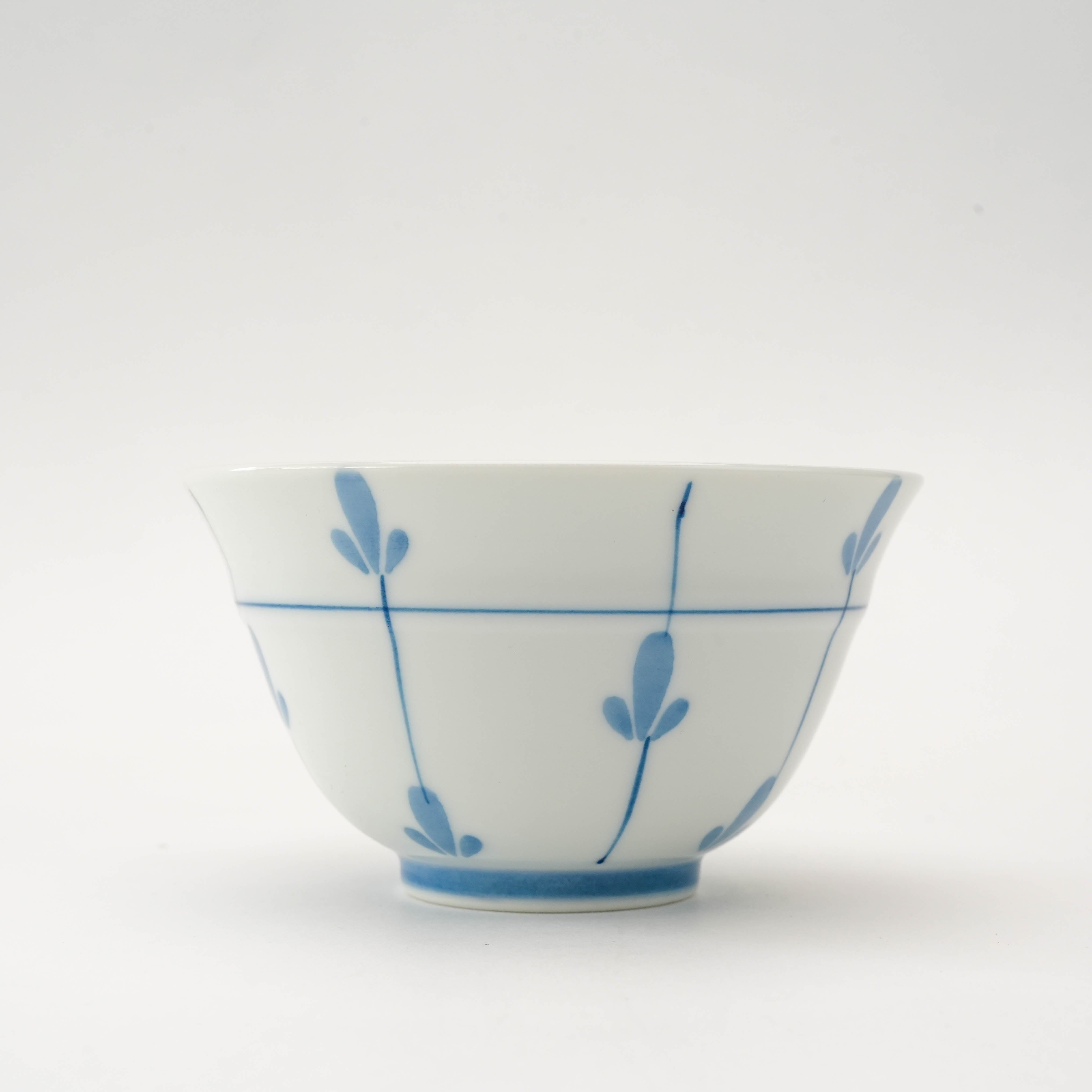 Close-up of Arita Ware Sprout Sencha Tea Cup showcasing delicate blue sprout motif. Elegant addition to Japanese tea drinkware.
