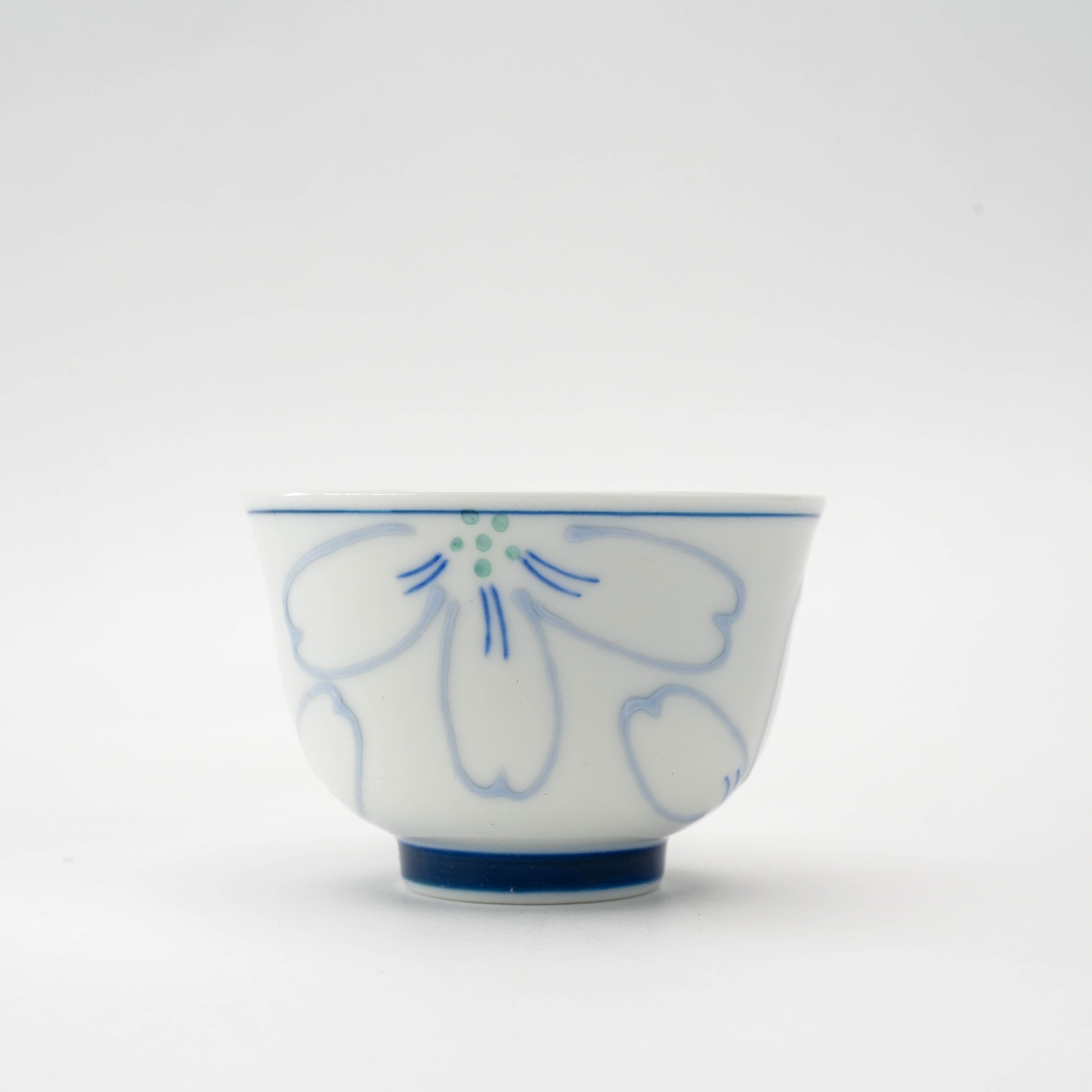 Close-up of Arita Ware celebration Sencha Tea Cup with delicate blue cherry blossom motif, perfect for refined tea service.