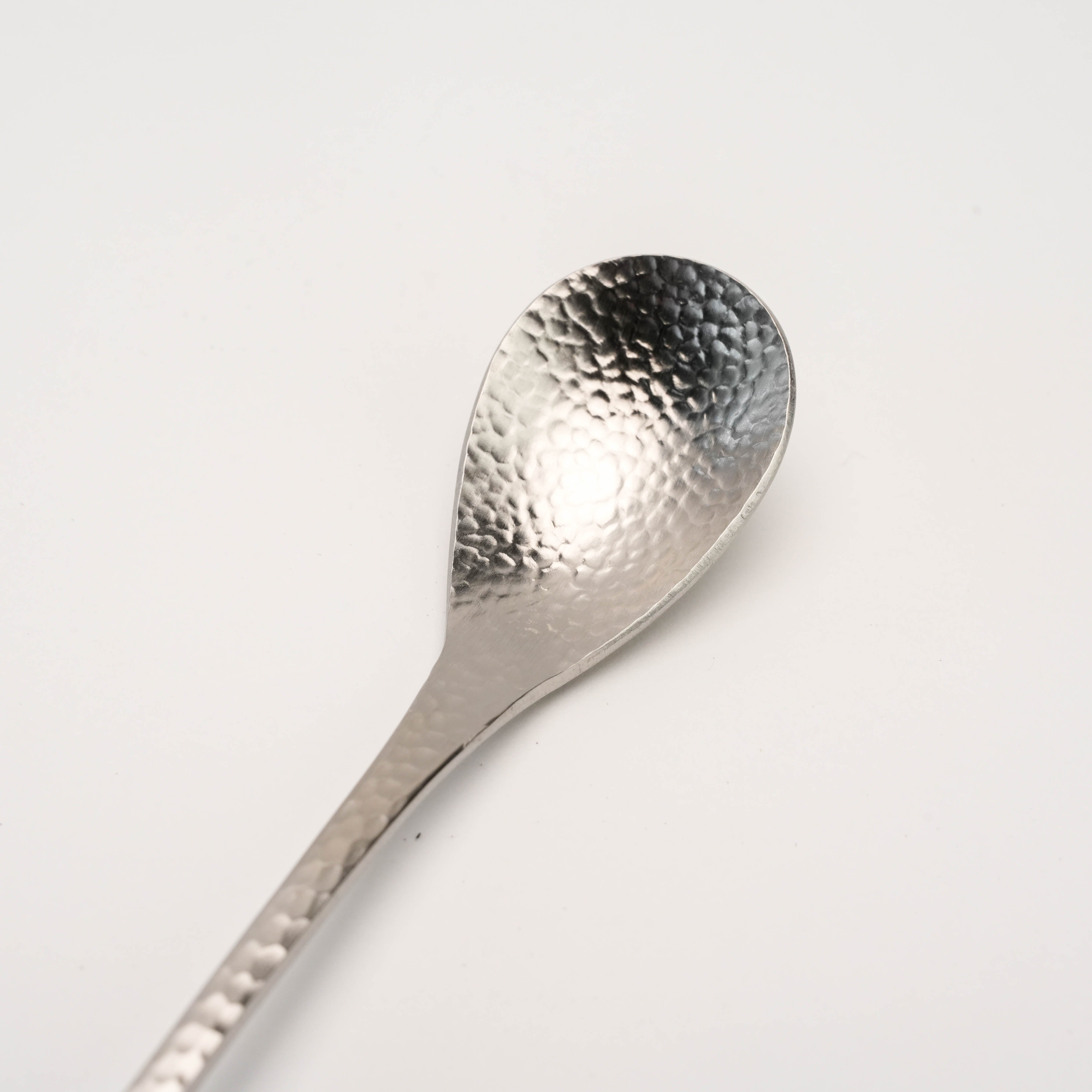Close-up of Tsubamesanjo Nagomi Wafu Drink Stirrer showing detailed hammered stainless steel texture for artisanal cocktail preparation.