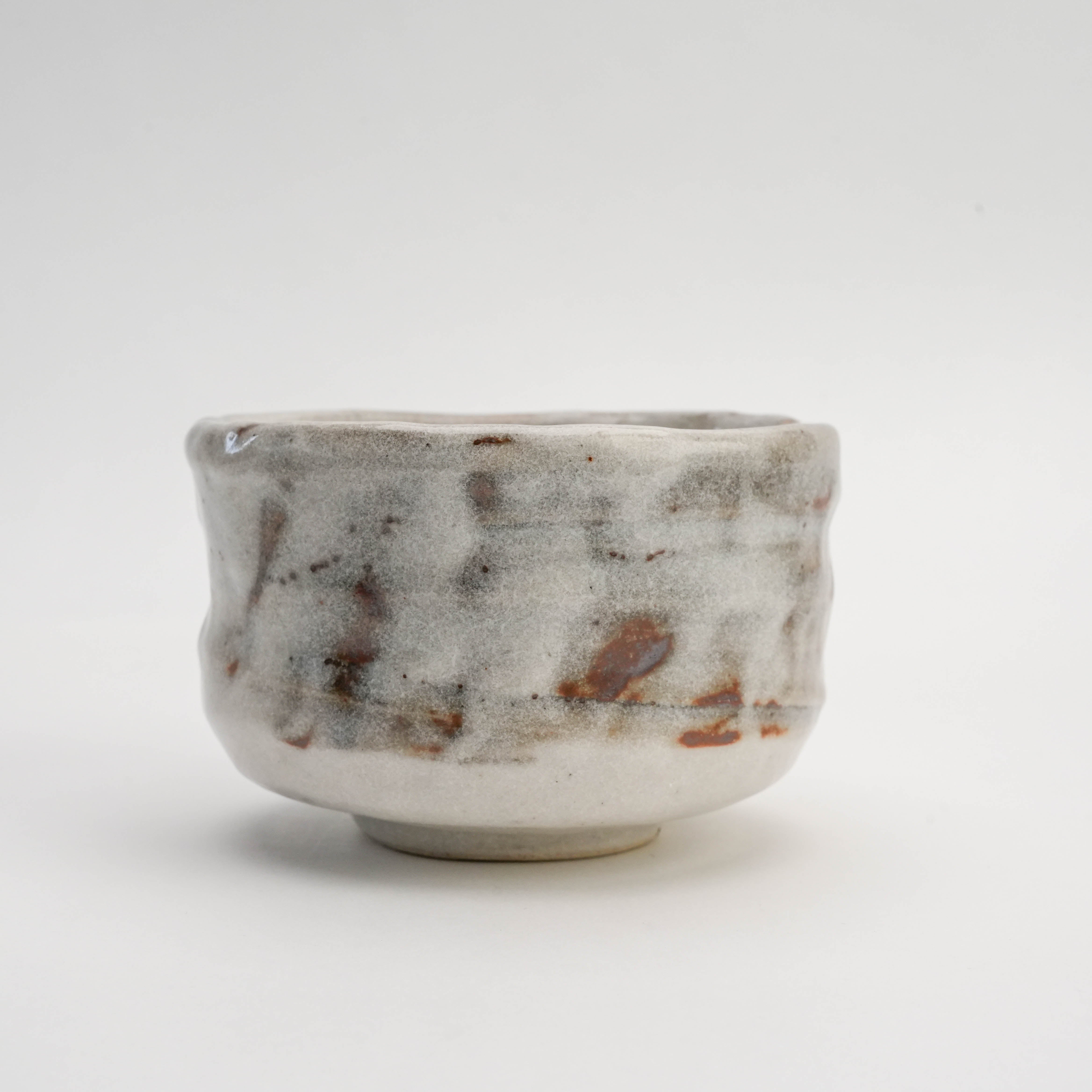 Handcrafted Mino Ware Nodate Oni-Shino Matcha Bowl featuring a textured, organic form and traditional Japanese glaze for tea or decorative use.