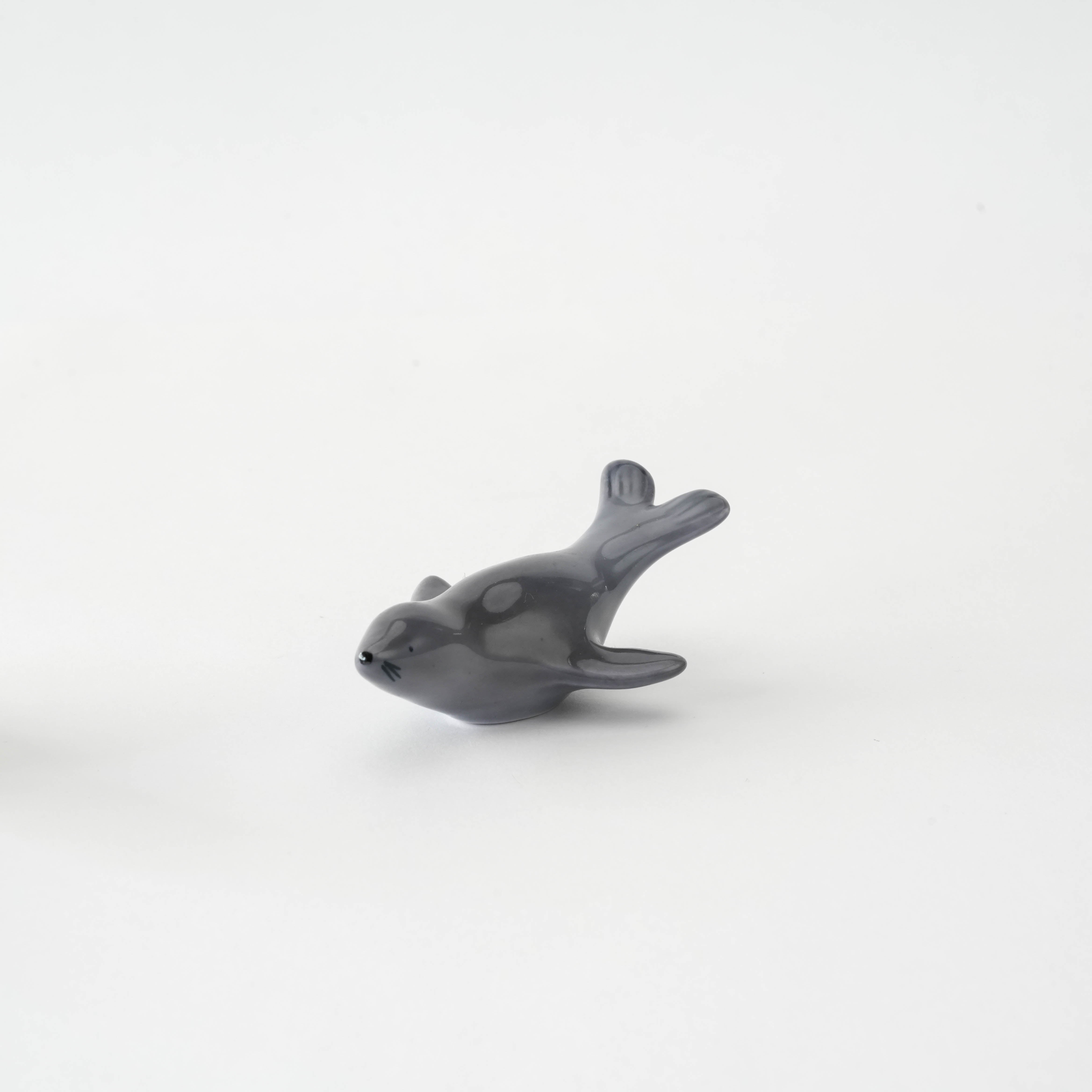 Porcelain Arita Ware Fur Seal Chopstick Rest with a playful swimming pose, perfect for enhancing coastal-inspired dining aesthetics.
