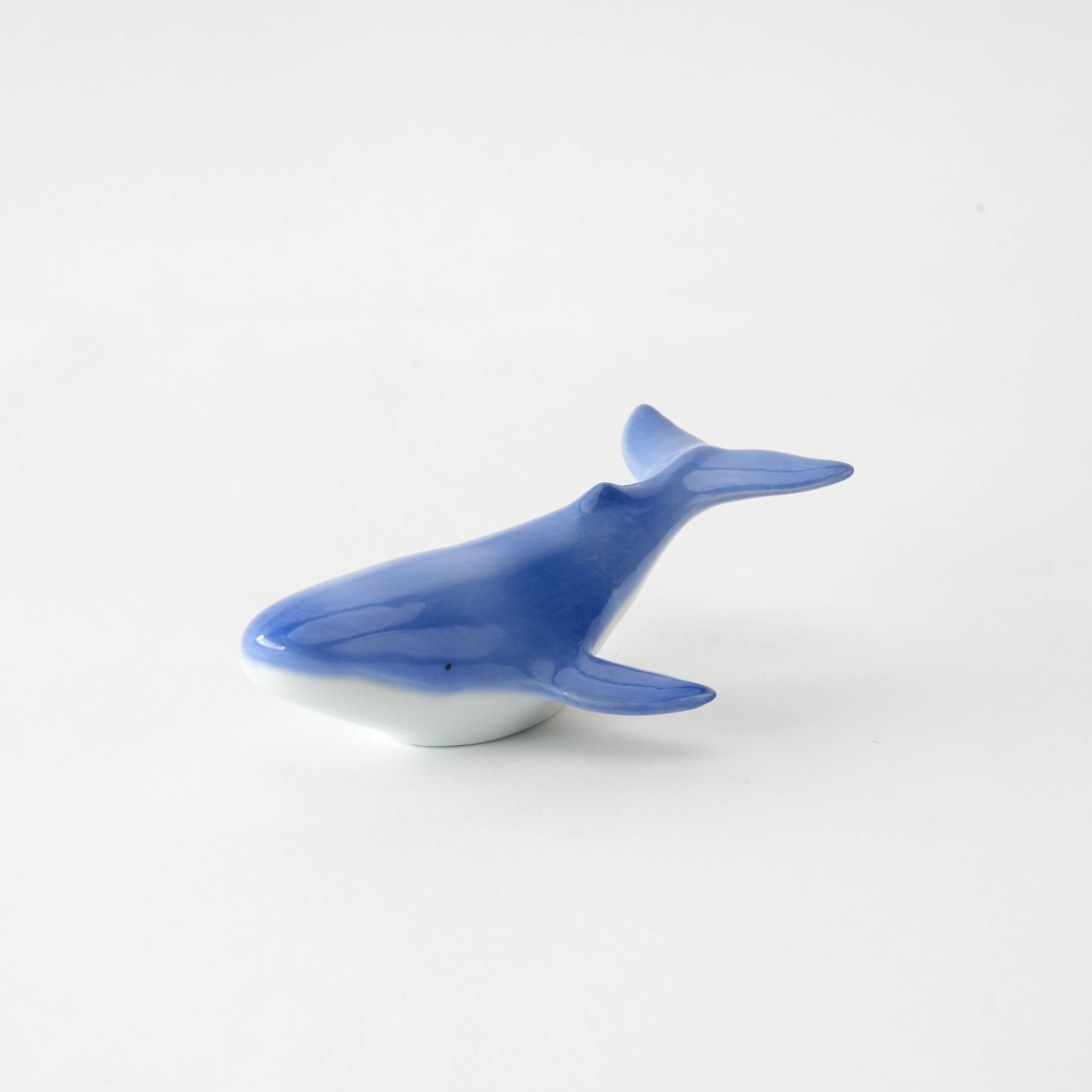 Side view of Arita Ware Whale Chopstick Rest with curved tail and glossy blue finish, perfect for ocean-themed dining decor.