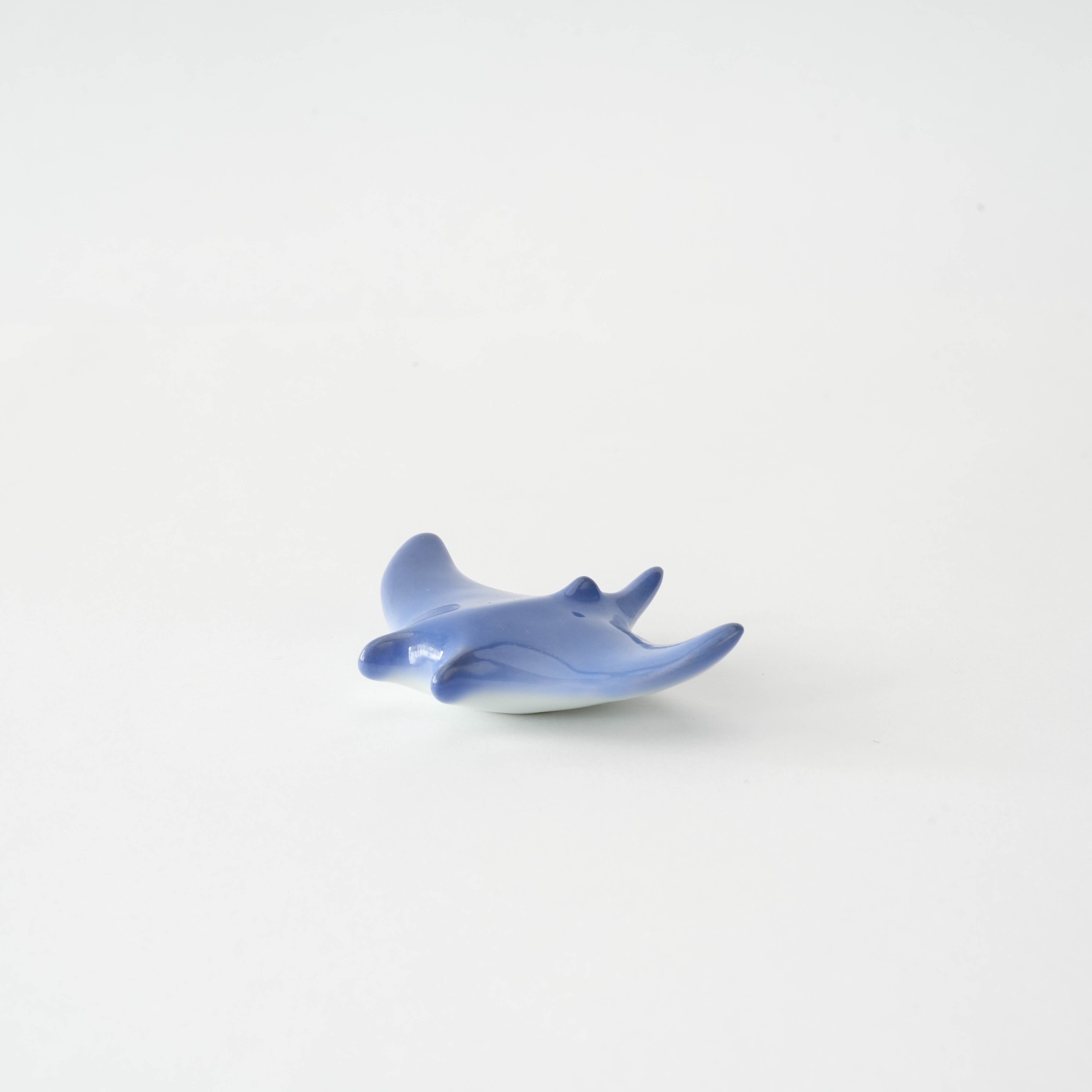 Arita Ware Manta Ray Chopstick Rest in glossy ocean blue porcelain, designed for stylish utensil placement in modern kitchens.