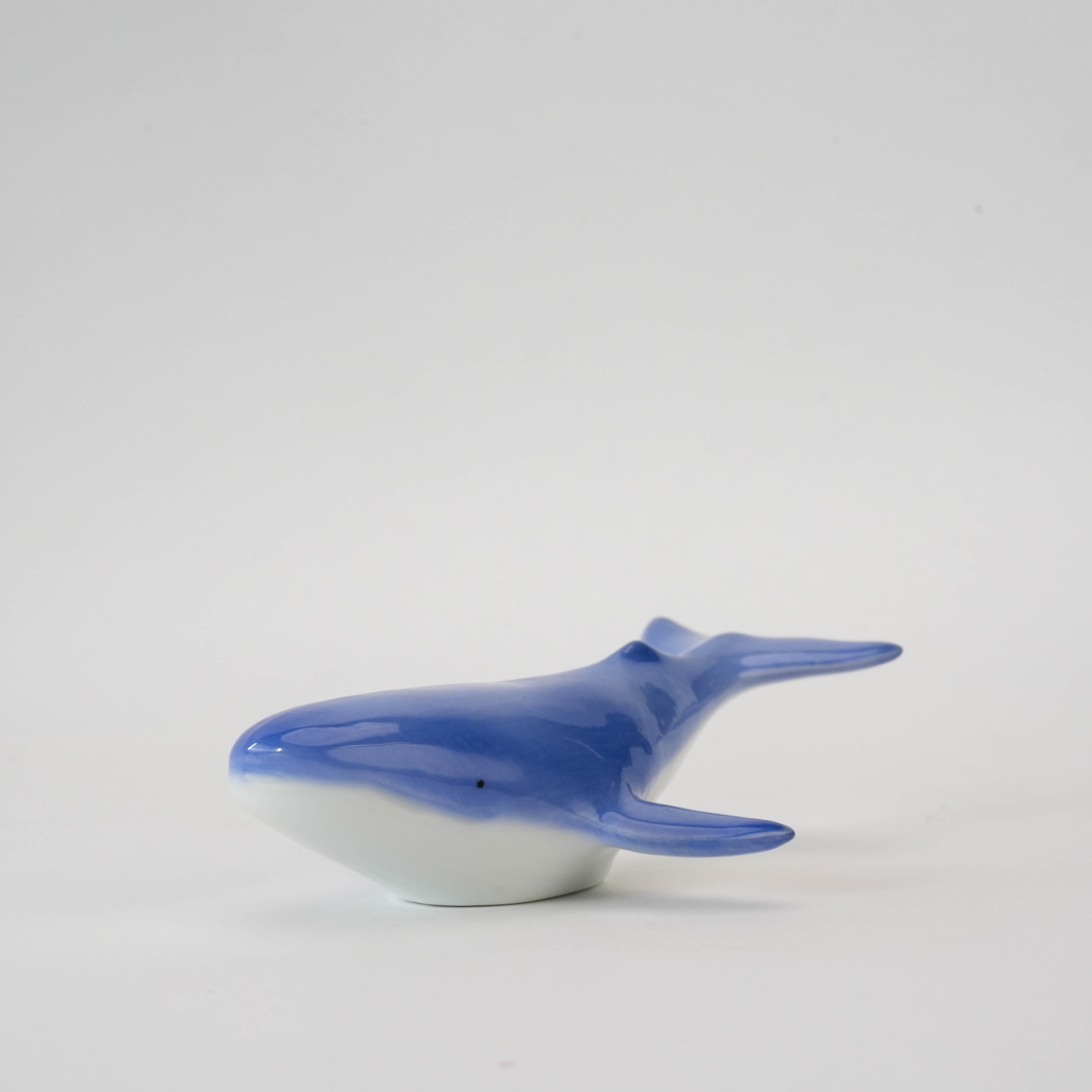 Close-up of Arita Ware Humpback Whale Chopstick Rest showcasing smooth ocean-blue glaze and detailed whale design.