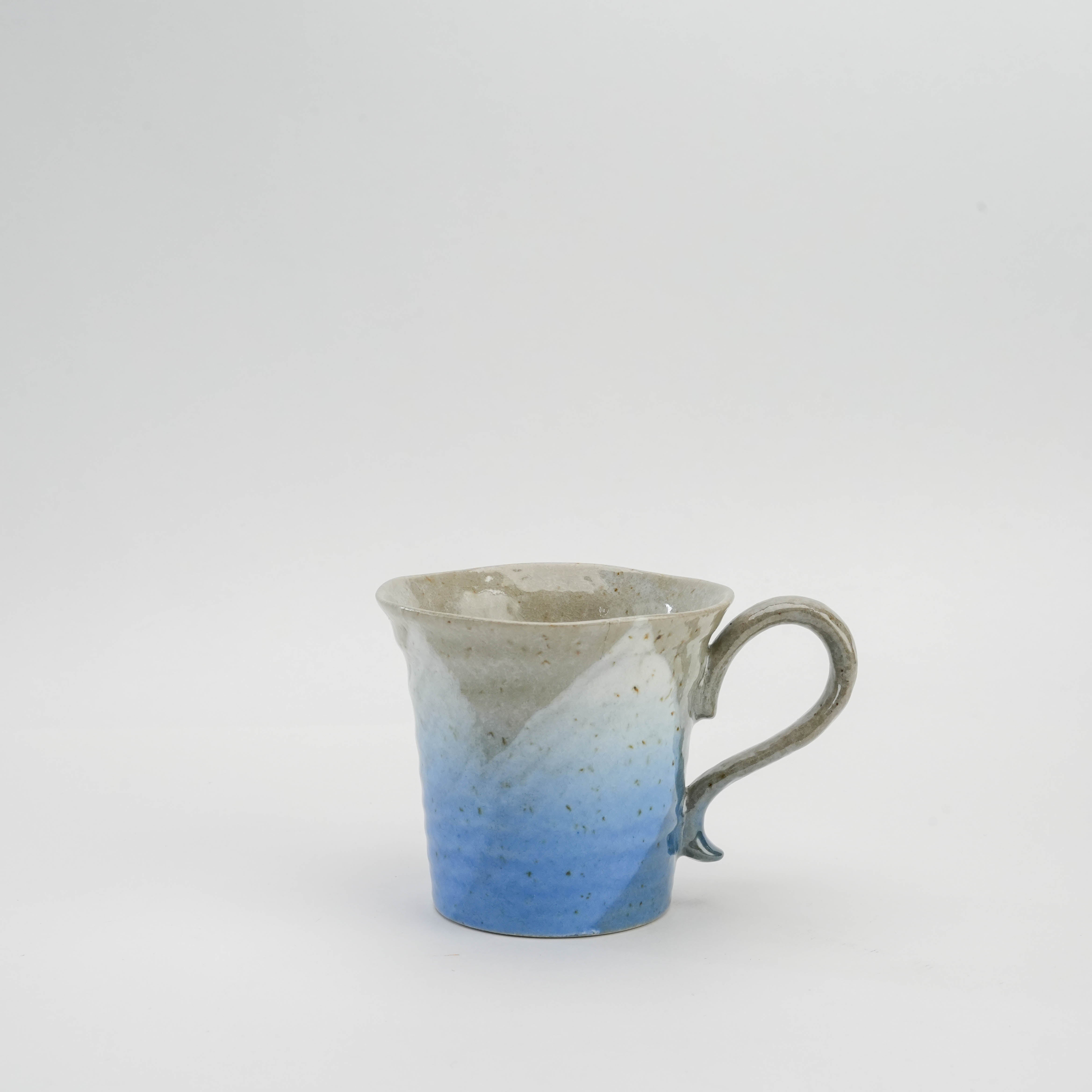 Kutani Ware Sakura Mug in ocean blue glaze with speckled porcelain finish and curved handle, ideal for tea or coffee. Japanese porcelain drinkware.
