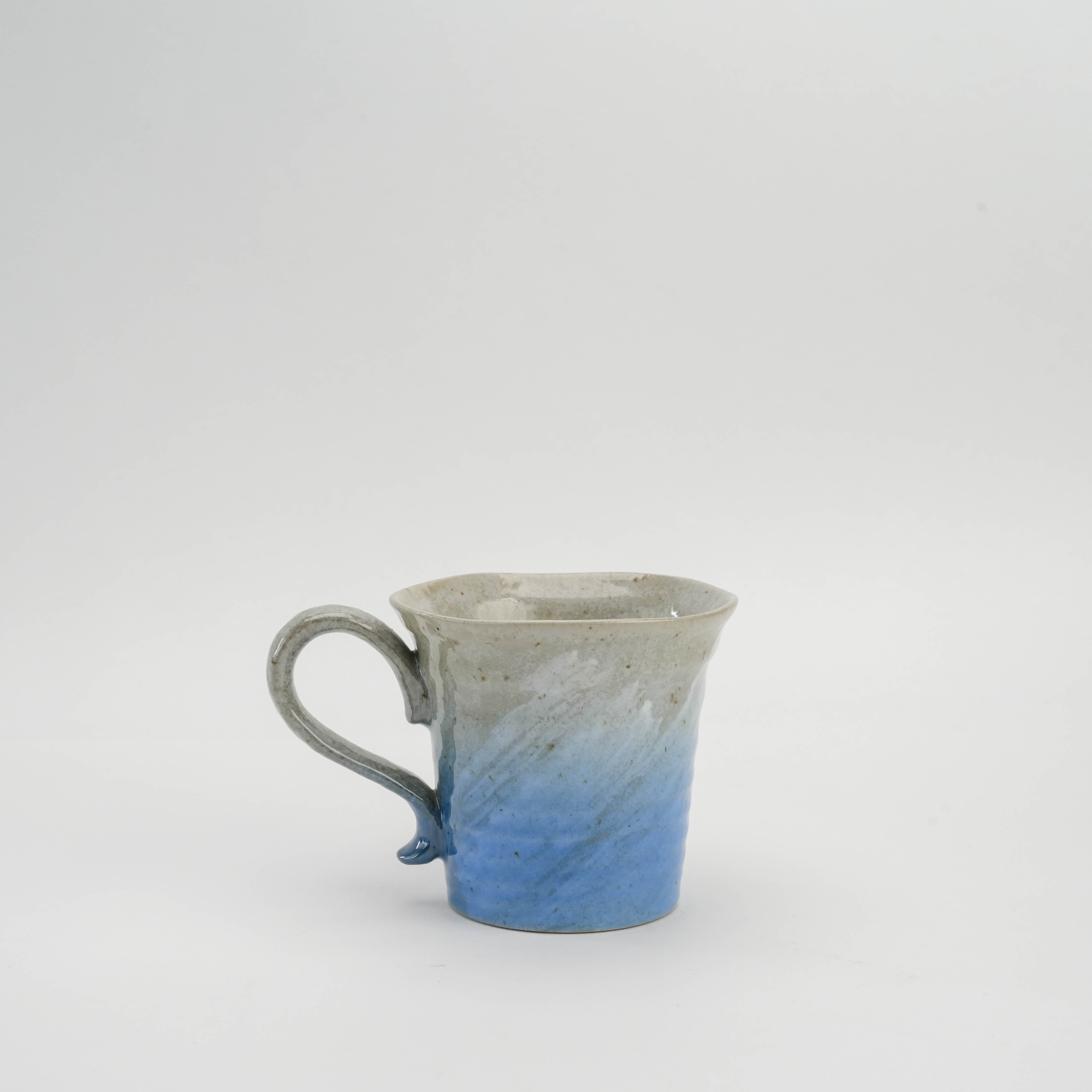 Ocean blue Kutani Ware Sakura Mug with gradient glaze and handcrafted texture, perfect for elegant Japanese-style table settings.