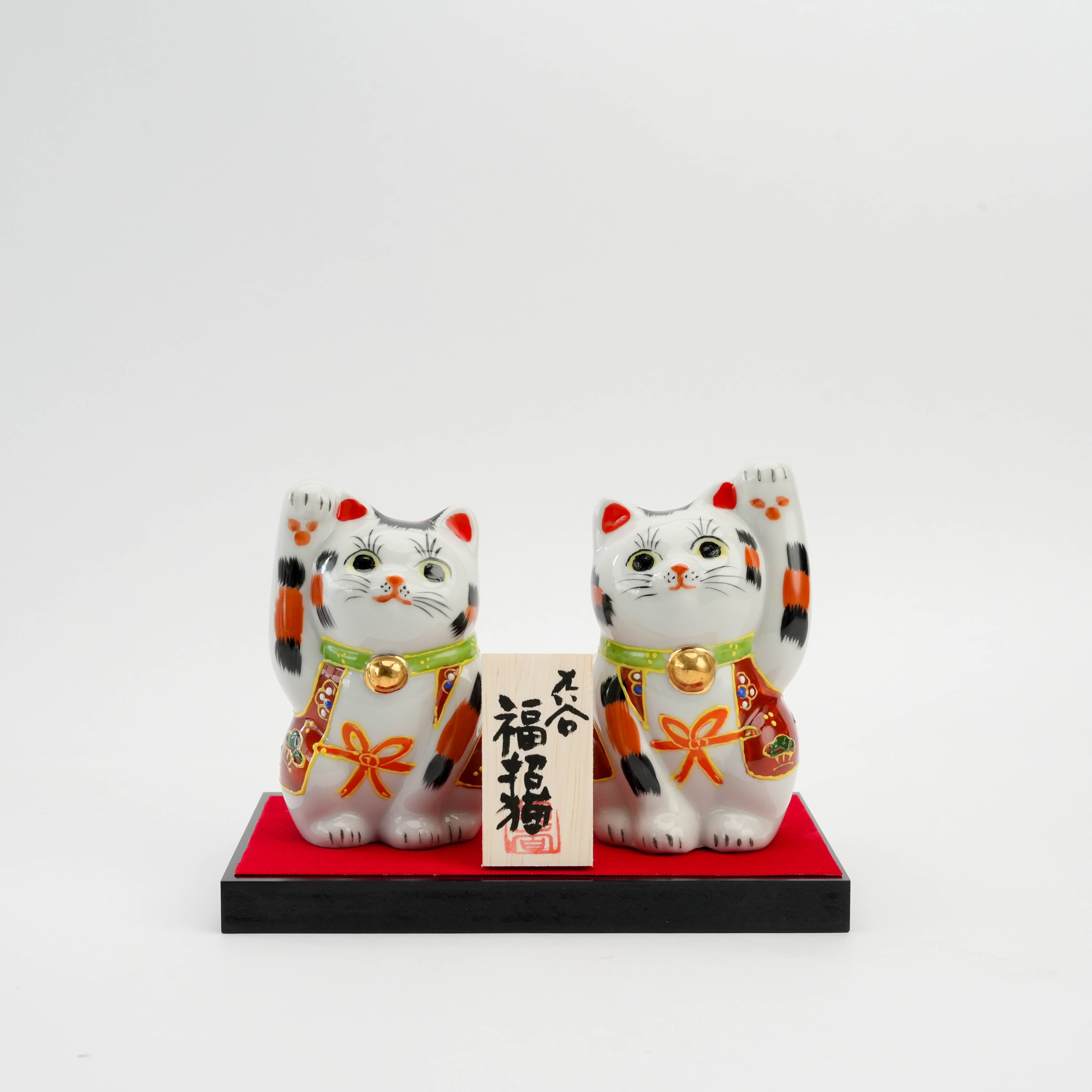 Kutani Calico Lucky Cats - Custom Cat Ornament set featuring two hand-painted Maneki-neko figurines on a red base, ideal for home decor or gifting.